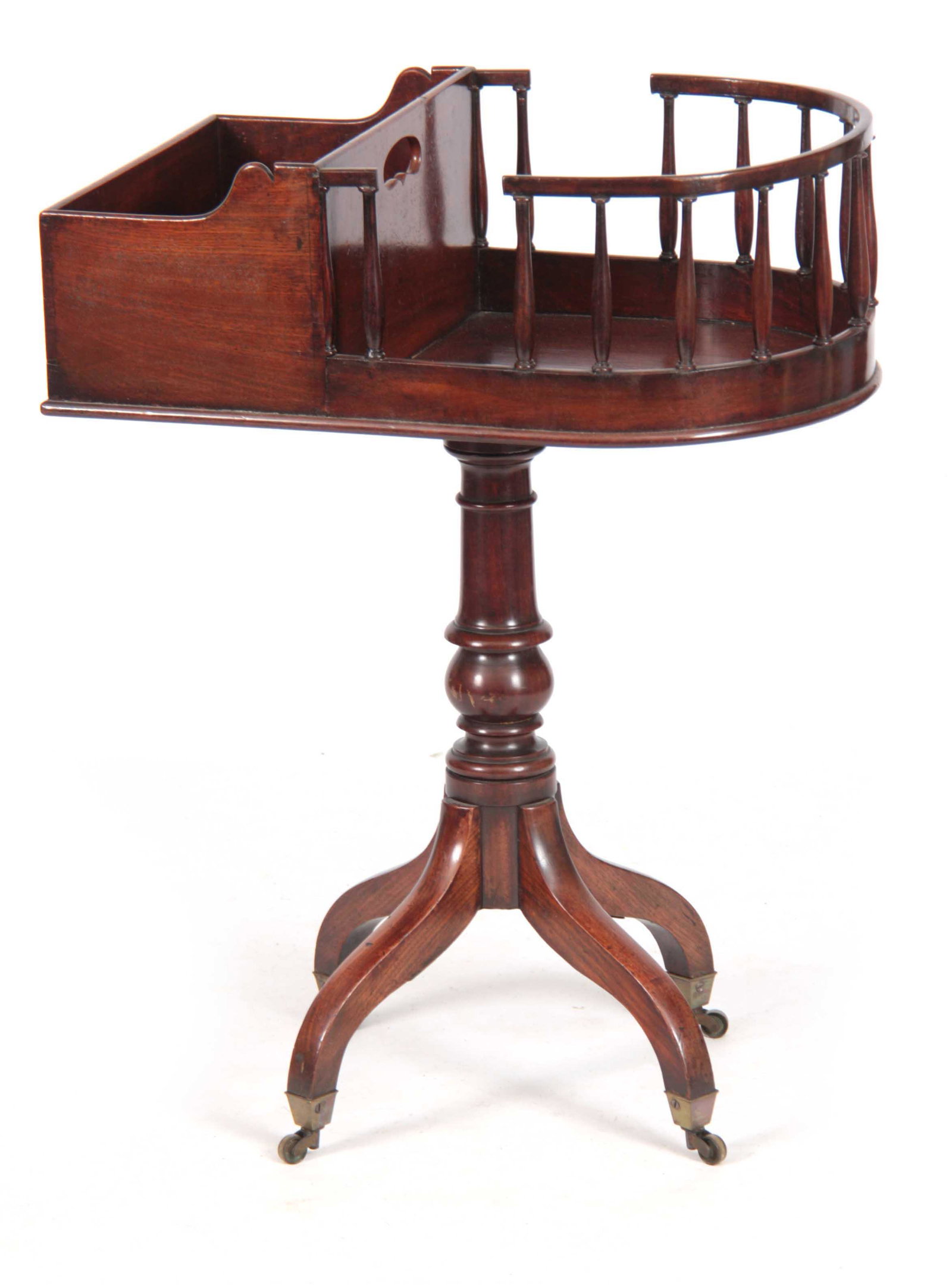 A LATE GEORGIAN MAHOGANY PORTABLE BUTLERS STAND with: A LATE GEORGIAN MAHOGANY PORTABLE BUTLERS STAND with divided box top and bowed galleried drinks tray, the revolving top on a ringed baluster stem and quadruple arched splayed base with under castors 5