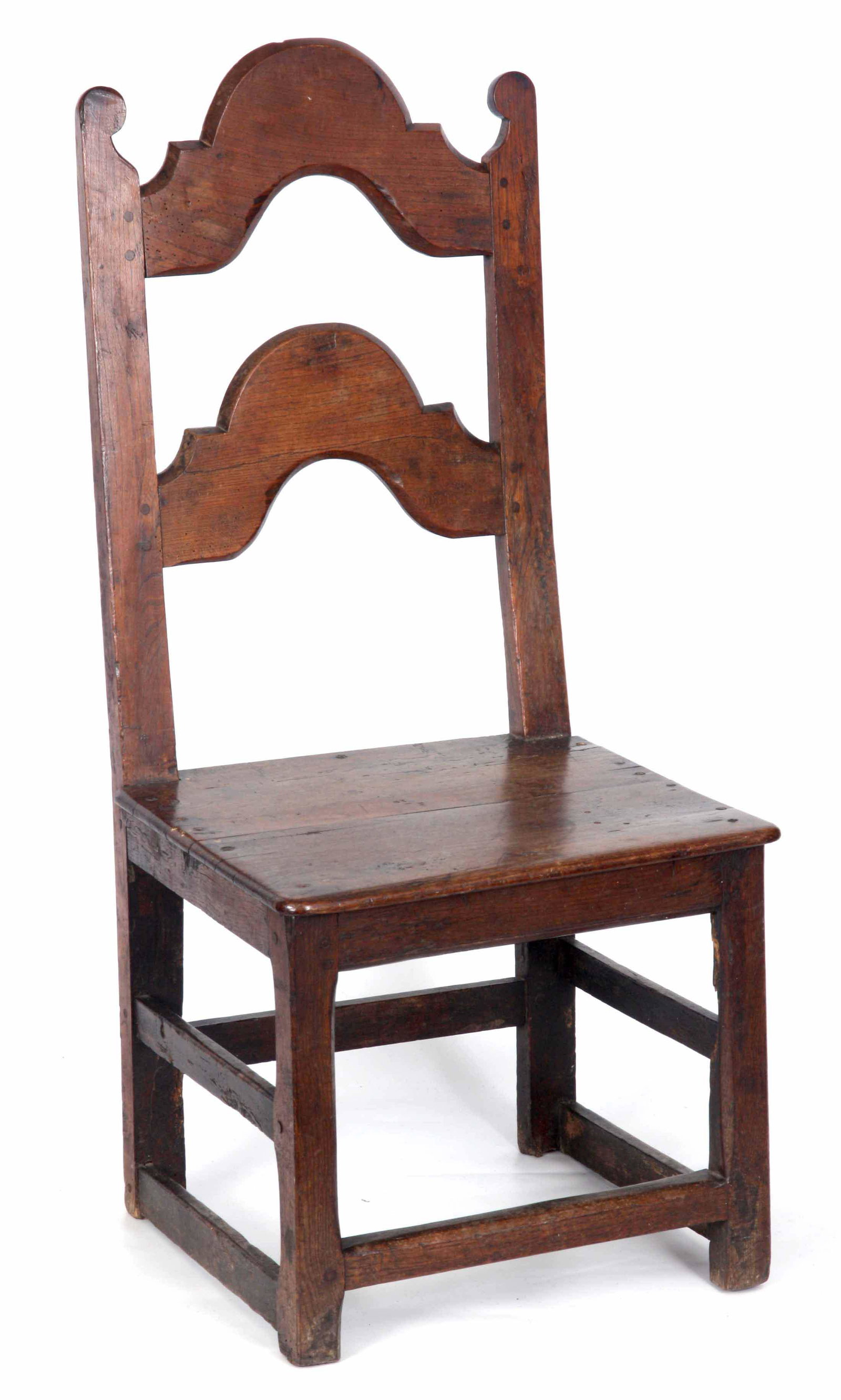A LATE 18TH CENTURY JOINED OAK SIDE CHAIR with ar: A LATE 18TH CENTURY JOINED OAK SIDE CHAIR with arched splat back and plank seat; standing on square chamfered legs joined by under stretchers 48cm wide 95cm high.