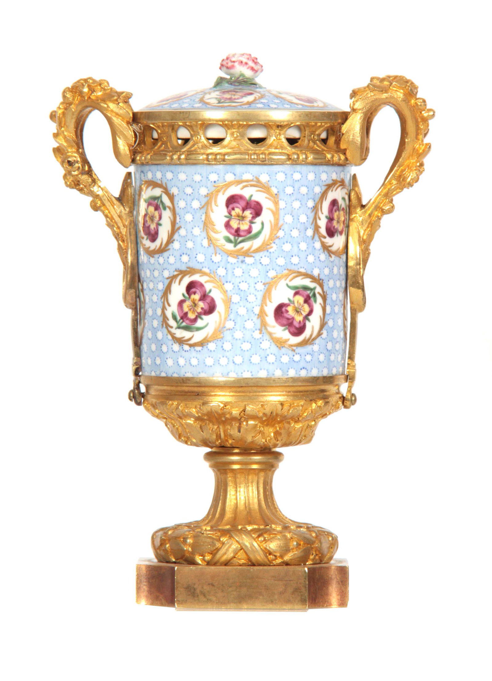 AN 18th CENTURY SEVRES PORCELAIN ORMOLU MOUNTED PE: AN 18th CENTURY SEVRES PORCELAIN ORMOLU MOUNTED PEDESTAL VASE with flowerhead finial and foliate handpainted body flanked by ormolu foliate swag handles on a fluted pedestal with acanthus leaf decorat