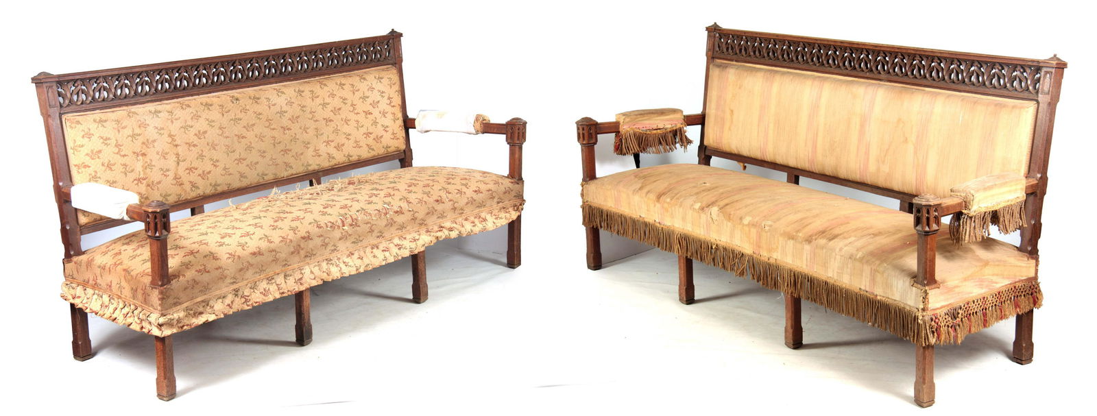 A PAIR OF 19TH CENTURY GOTHIC OAK THREE SEATER BEN: A PAIR OF 19TH CENTURY GOTHIC OAK THREE SEATER BENCHES / SETTEES IN THE MANER OF PUGIN with pierced carved top rails above upholstered backs and seats, open arms with castellated carved supports; stan