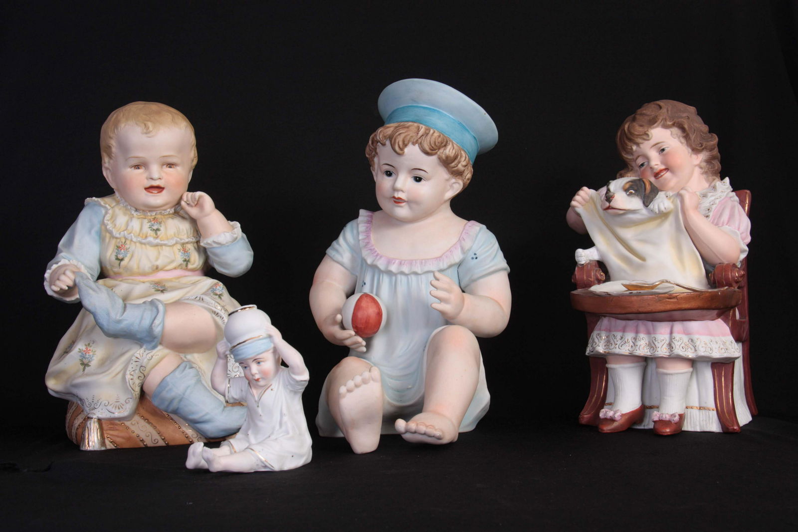 A LARGE KPM BISQUE FIGURE depicting a seated boy d (1 of 1)