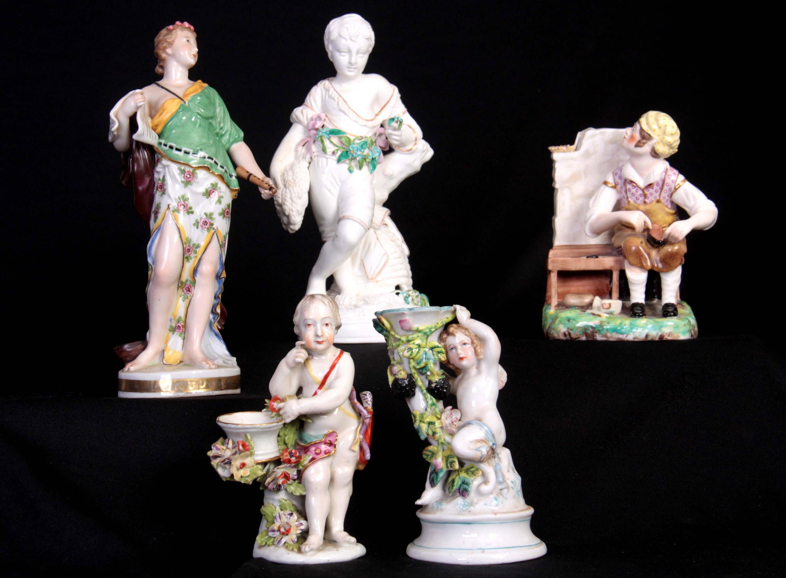 A 19TH CENTURY S & H DERBY SEATED FIGURE OF A COBL: A 19TH CENTURY S & H DERBY SEATED FIGURE OF A COBLER 14cm high A DERBY STYLE FLORALLY ENCRUSTED FIGURE OF CUPID 13.5cm high A MINTON/EARLY WORCESTER TYPE FIGURE OF HARVEST 20.5cm high A VIENNA TYPE ST