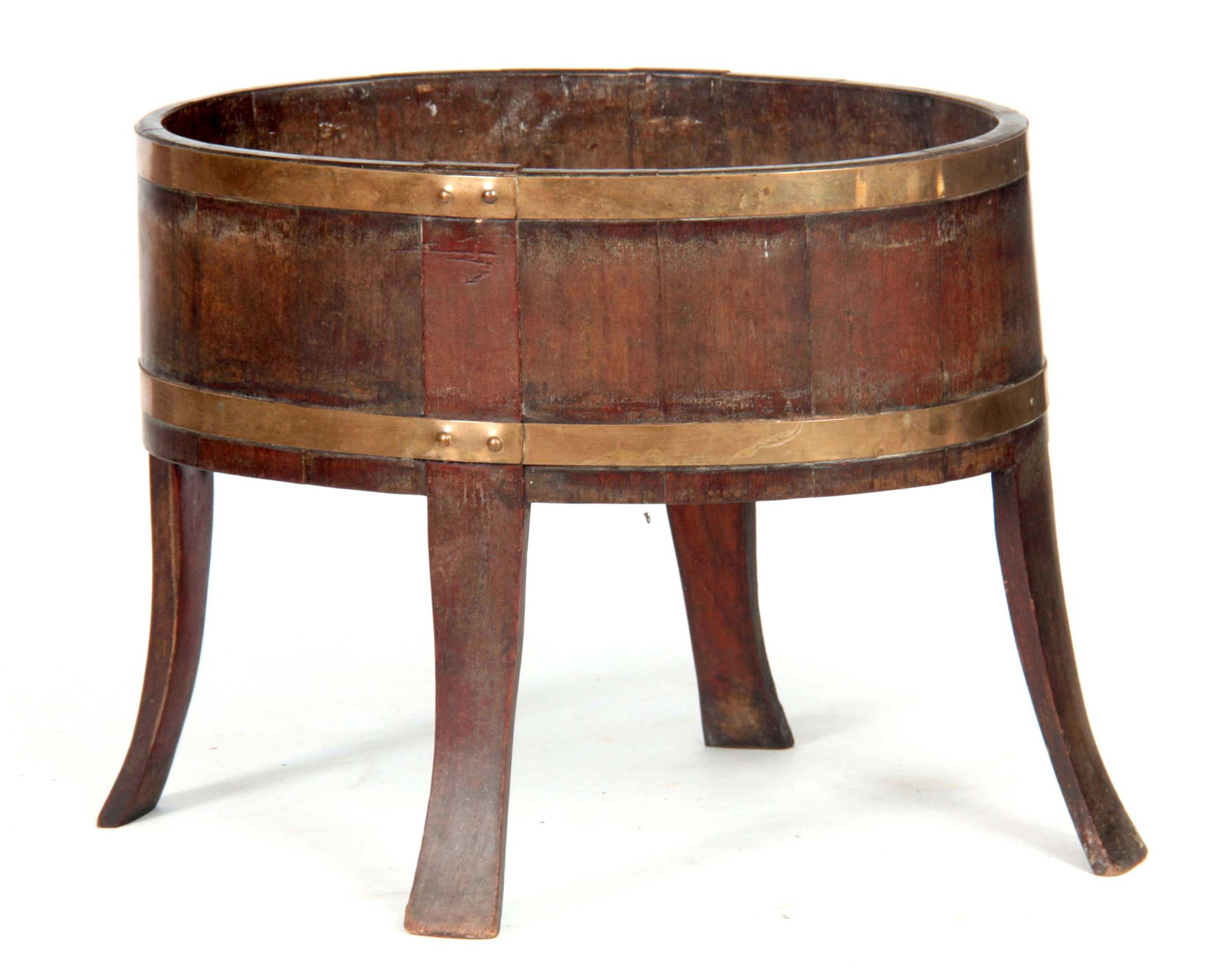 A GEORGE III LARGE OVAL MAHOGANY OPEN WINE COOLER: A GEORGE III LARGE OVAL MAHOGANY OPEN WINE COOLER with brass strapped body on flattened shaped tapering flared legs - top 65.5cm wide 42.5cm deep 52cm high - stamped beneath A.H ... and with registrat