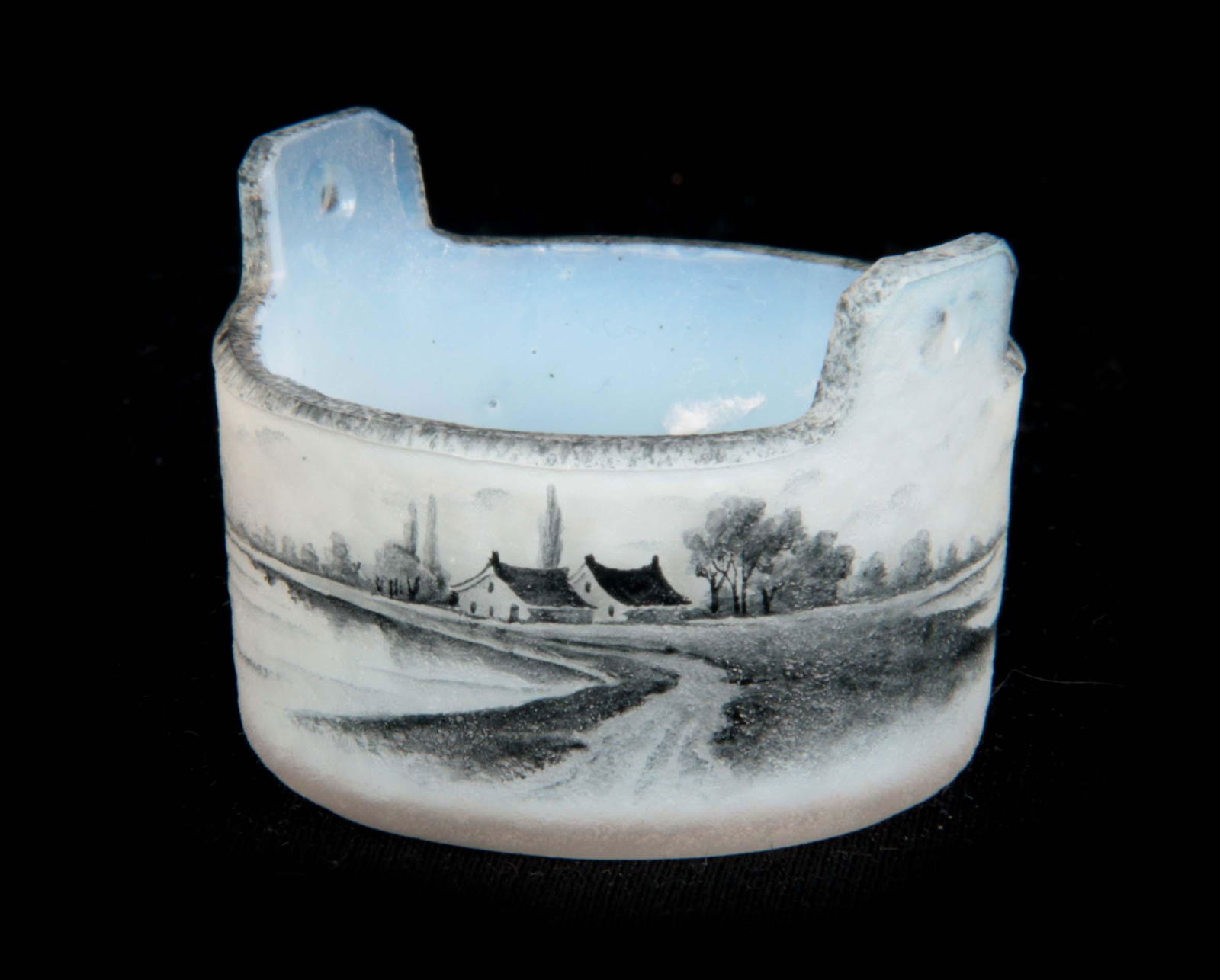 DAUM, NANCY. A MINIATURE GLASS SALT PAIL very finely: DAUM, NANCY. A MINIATURE GLASS SALT PAIL very finely detailed with a Dutch landscape decorated en grisaille with Windmills and a Lakeside landscape with sailing boats, 44mm diameter Signed in enamel t