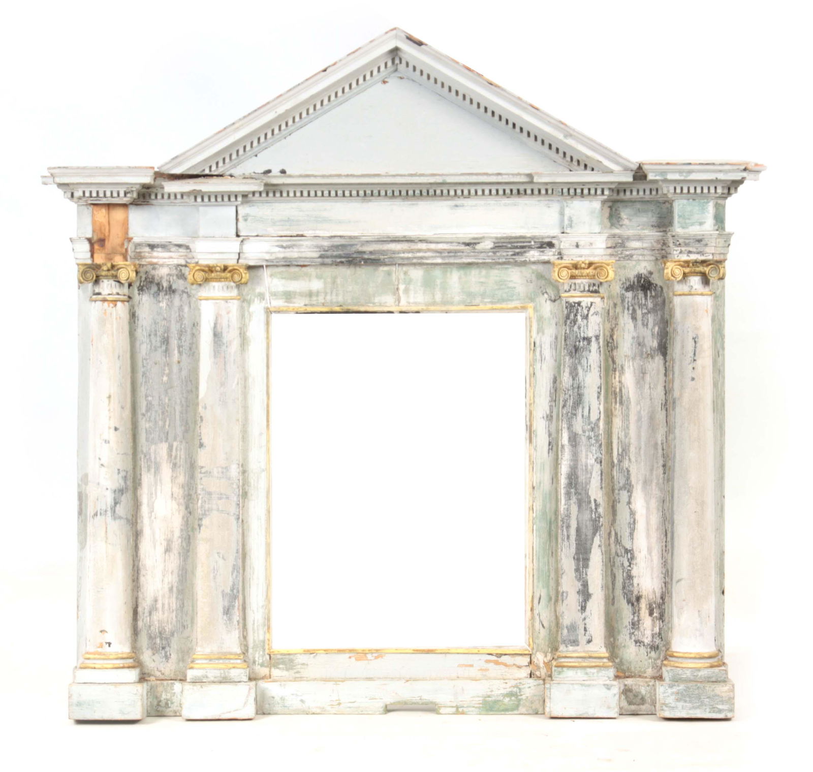 AN 18TH CENTURY PAINTED AND GILT CARVED PINE OVERMANTEL: AN 18TH CENTURY PAINTED AND GILT CARVED PINE OVERMANTEL MIRROR IN THE MANNER OF WILLIAM KENT with architectural pediment above Corinthian columns, mirror plate missing 124cm wide 122cm high