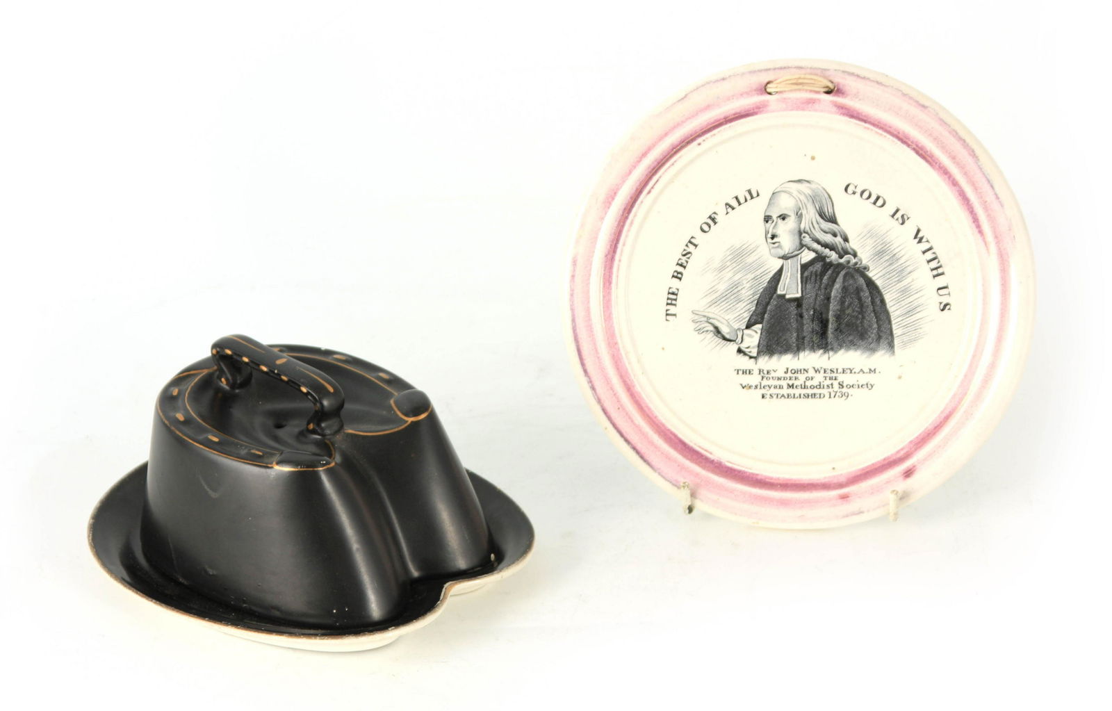 A 19TH CENTURY SUNDERLAND TYPE CERAMIC WALL PLAQUE: A 19TH CENTURY SUNDERLAND TYPE CERAMIC WALL PLAQUE RELATING TO REV. JOHN WESLEY, A.M. with transfer printed centre portrait 18.5cm diameter TOGETHER WITH A SMALL HORSESHOE SHAPED CHEESE DISH 18cm over