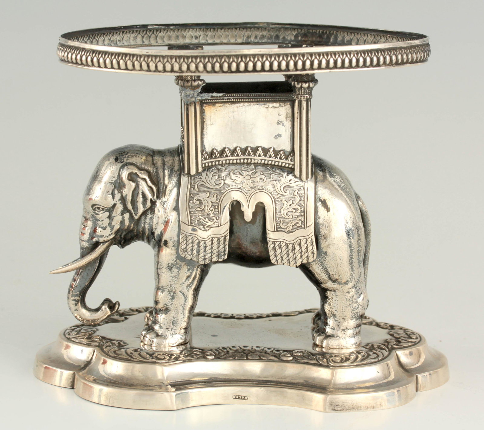 A 19TH CENTURY EUROPEAN SILVER CENTREPIECE STAND: A 19TH CENTURY EUROPEAN SILVER CENTREPIECE STAND depicting a standing Elephant mounted on a moulded shaped base 12cm high 14.5cm wide
