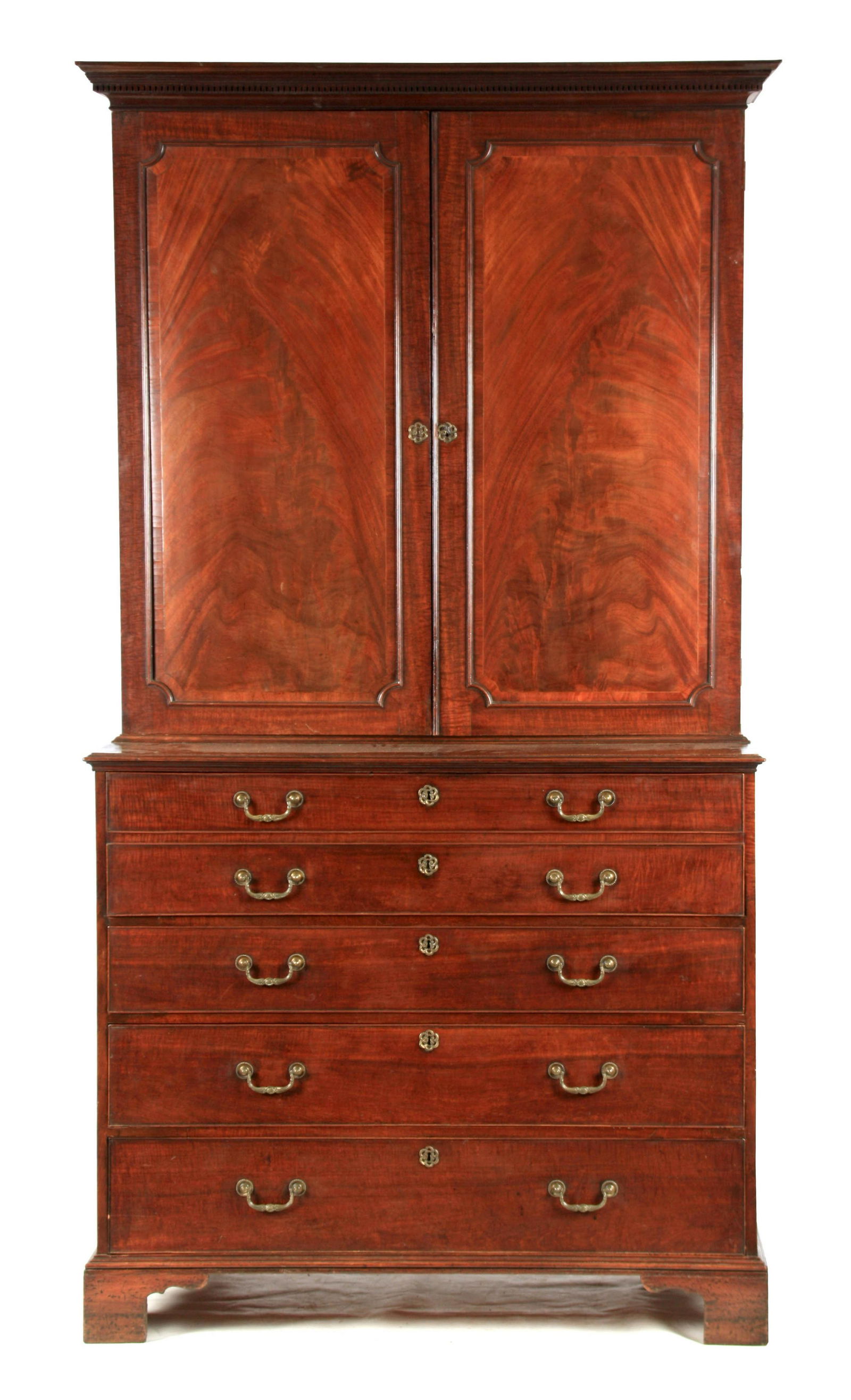 A GEORGE III FIDDLE-BACK MAHOGANY SECRETAIRE BOOKCASE: A GEORGE III FIDDLE-BACK MAHOGANY SECRETAIRE BOOKCASE IN THE MANNER OF THOMAS CHIPPENDALE with dentil moulded cornice above a pair of shaped cross-banded flame mahogany cupboard doors revealing a fitt