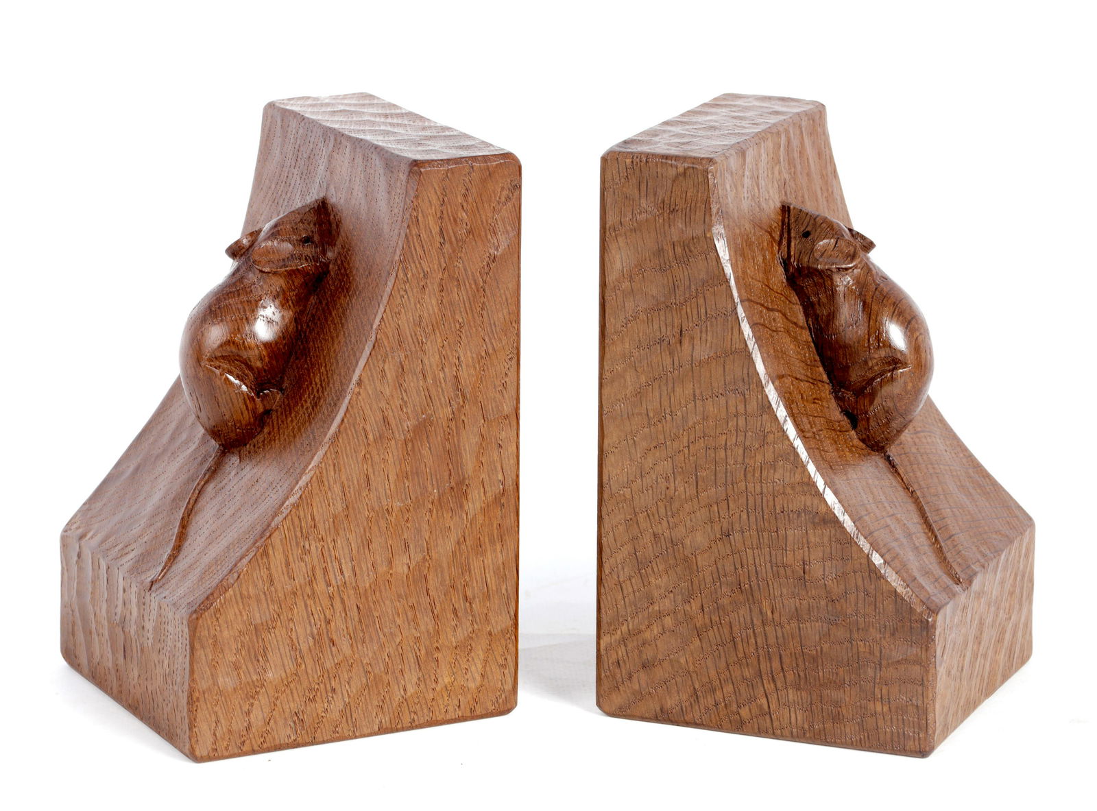 A GOOD PAIR OF ROBERT 'MOUSEMAN' THOMPSON AZED DARK OAK: A GOOD PAIR OF ROBERT 'MOUSEMAN' THOMPSON AZED DARK OAK BOOKENDS of curved angular form with bold carved mouse motifs. (9.5cm wide, 15cm high.)