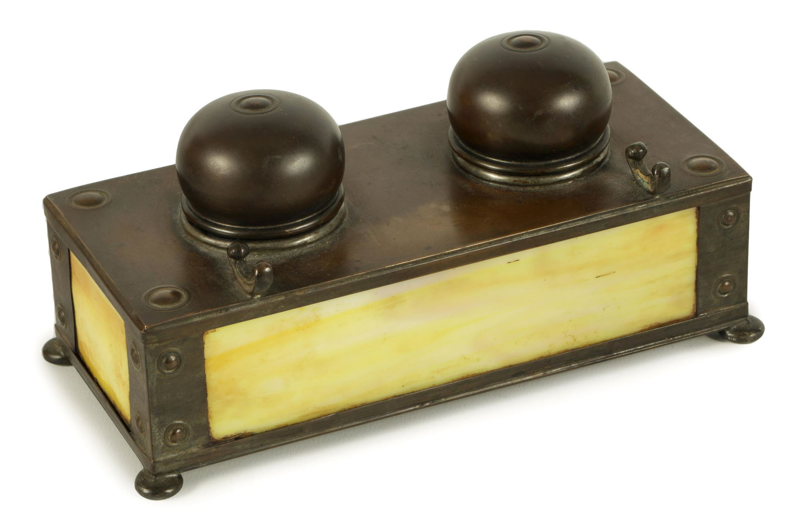 AN ARTS AND CRAFTS APOLLO STUDIOS NEW YORK AMERICAN PATINATED COPPER DOUBLE PEN AND INK STAND: AN ARTS AND CRAFTS APOLLO STUDIOS NEW YORK AMERICAN PATINATED COPPER DOUBLE PEN AND INK STAND with domed tops and slag glass side panels raised on shallow bun feet - stamped beneath (19cm wide 9cm dee