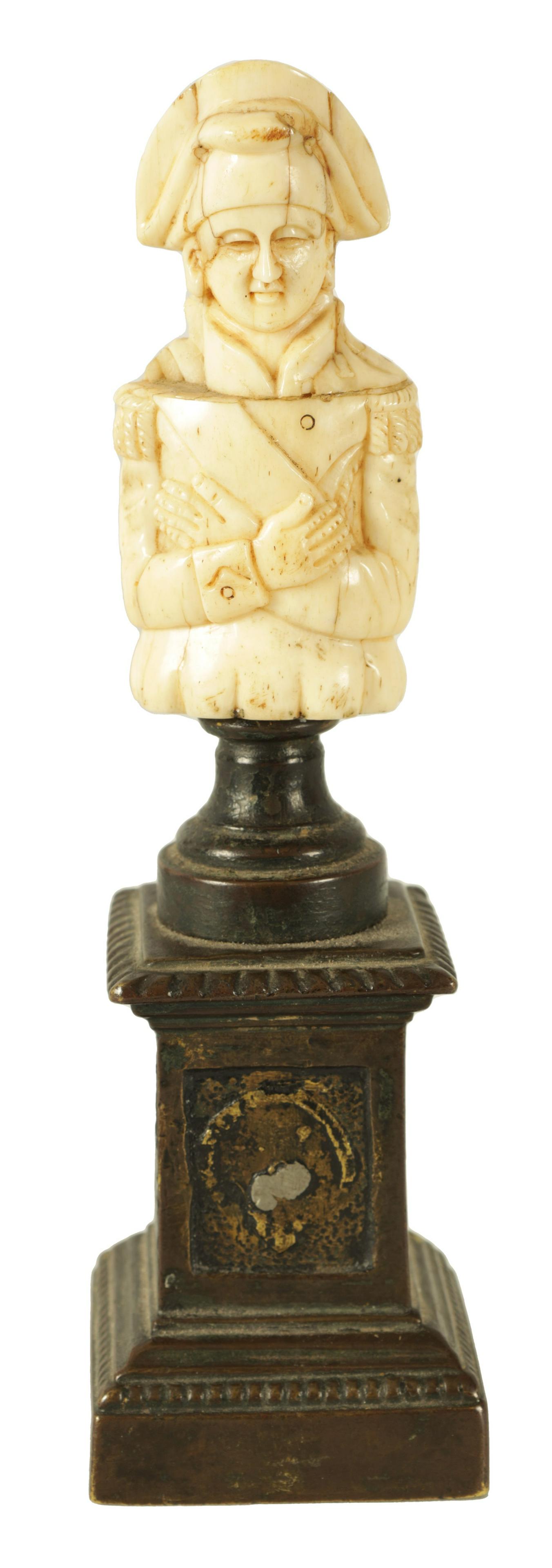 A 19TH CENTURY FRENCH BRONZE AND BONE CARVED SCULPTURE: A 19TH CENTURY FRENCH BRONZE AND BONE CARVED SCULPTURE Modelled as Napoleon Bonaparte raised on a panelled square bronze base (19.5cm high)