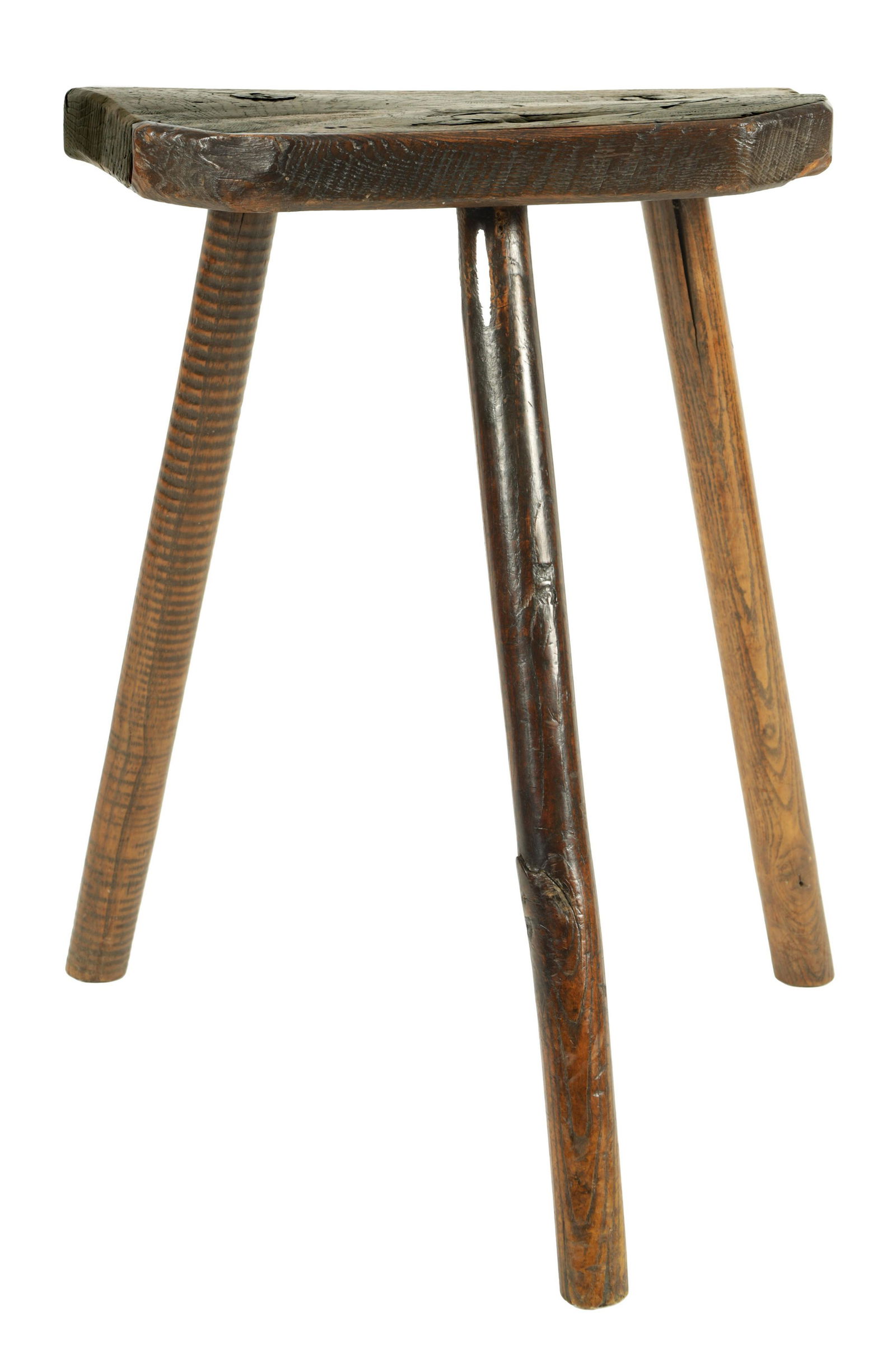 A 19TH CENTURY PRIMITIVE ELM CUTLERS STOOL with shaped plank seat and raised on a splayed turned (1 of 5)