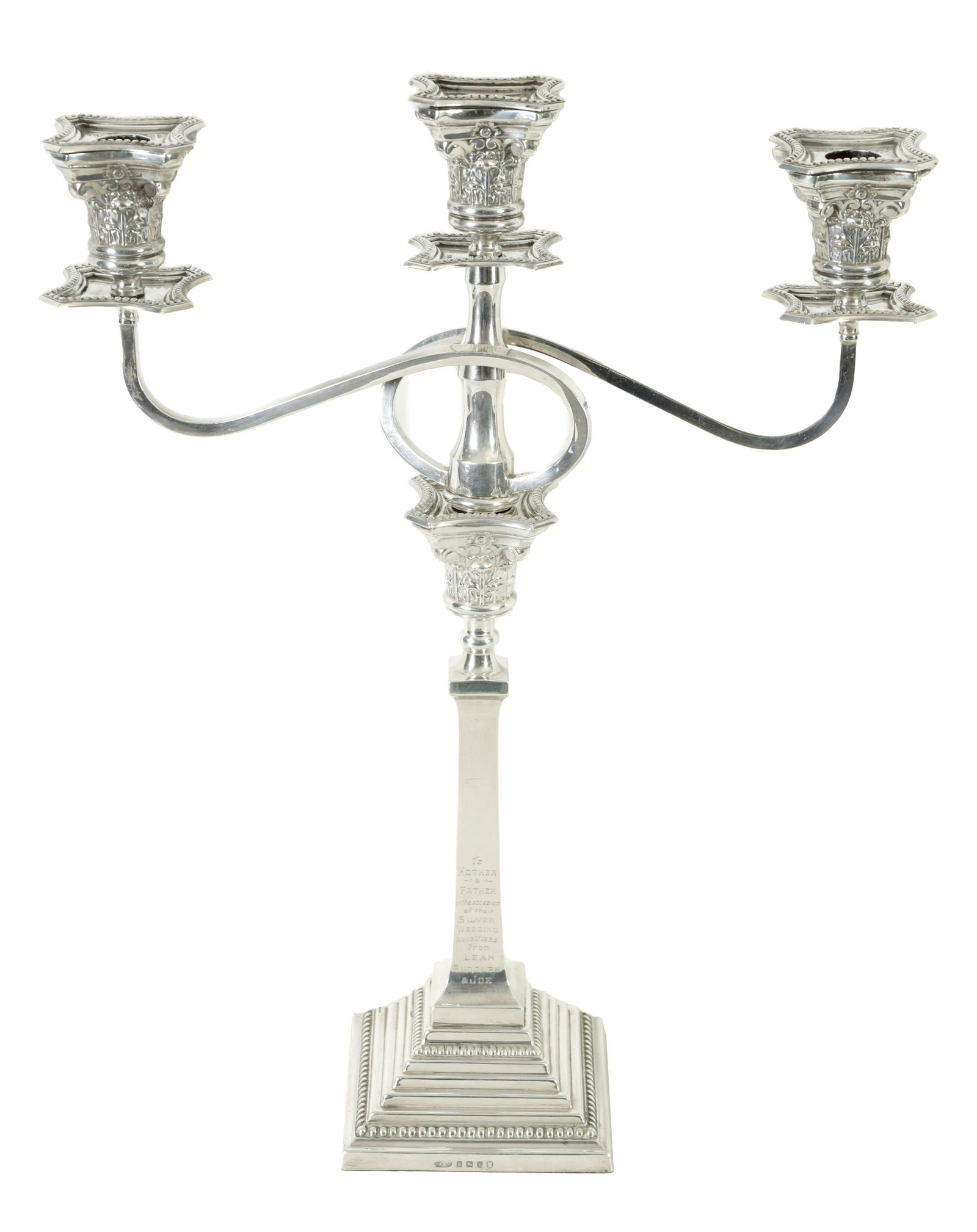 A GEORGE V SILVER THREE-BRANCH CANDELABRA: A GEORGE V SILVER THREE-BRANCH CANDELABRA with removable twisted square branches and lift-out sconces supported by a corinthian column topped stem on a stepped gadrooned base, bearing engraving to one