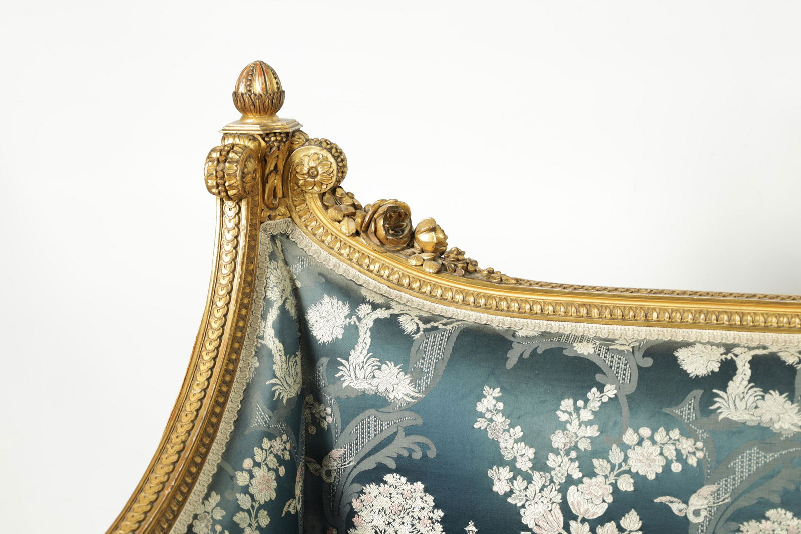 A FINE PAIR OF 19TH CENTURY CARVED GILT GESSO TWO-SEATER SETTEES: A FINE PAIR OF 19TH CENTURY CARVED GILT GESSO TWO-SEATER SETTEES the finely carved floral and leaf work frames raised on fluted tapering legs; covered in chinoiserie style silk upholstery. (135cm wide