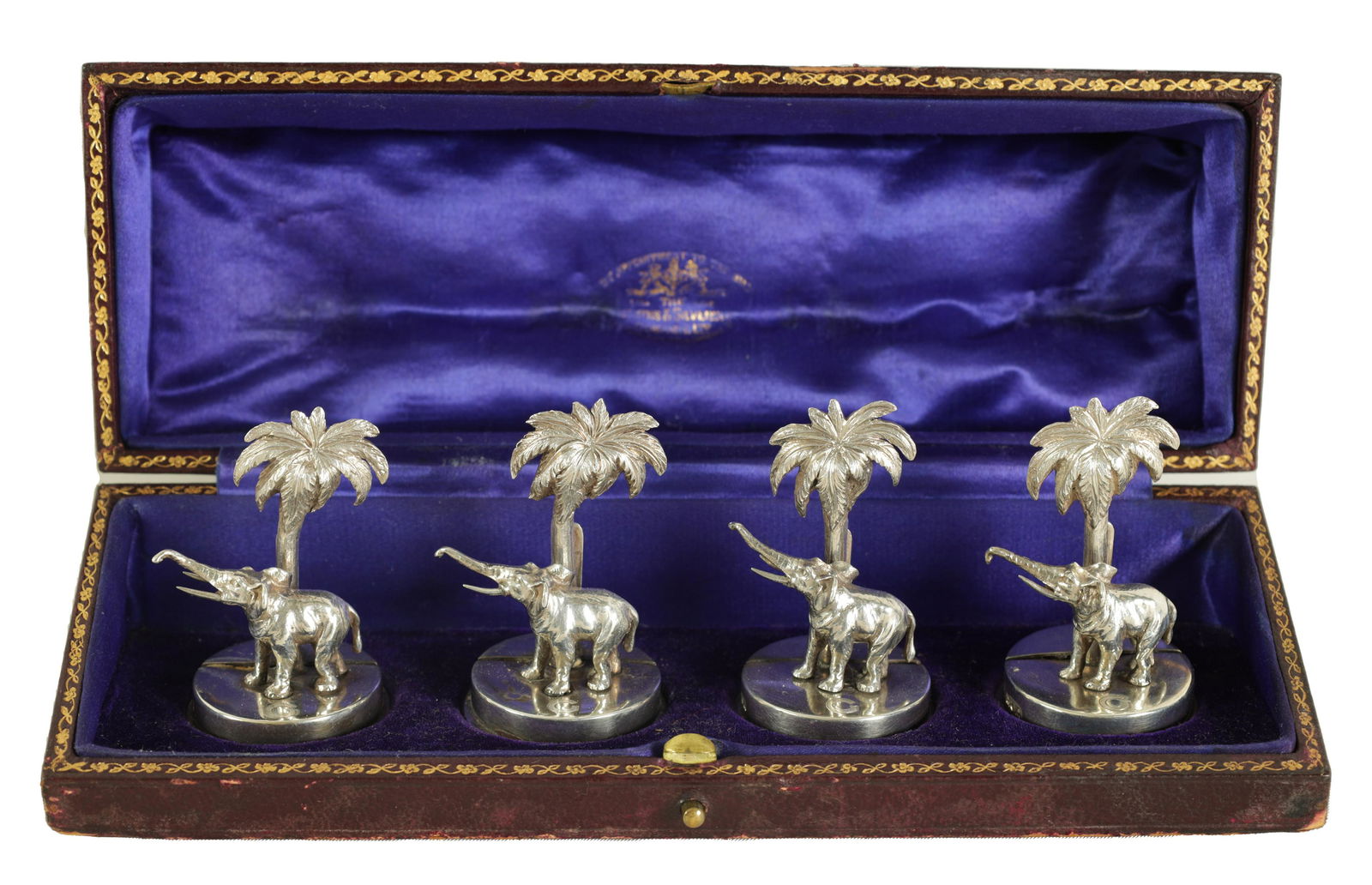 A CASED SET OF FOUR SILVER ELEPHANT AND PALM TREE MENU HOLDERS (1 of 7)