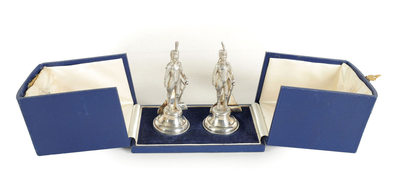A LARGE CASED PAIR OF SILVER ROYAL HORSE ARTILLERY SOLDIER MENU HOLDERS: A LARGE CASED PAIR OF SILVER ROYAL HORSE ARTILLERY SOLDIER MENU HOLDERS dressed in military uniform stood at ease, total approx weight 185g - by Goldsmiths & Silversmiths Company Ltd, London, 1939-40.