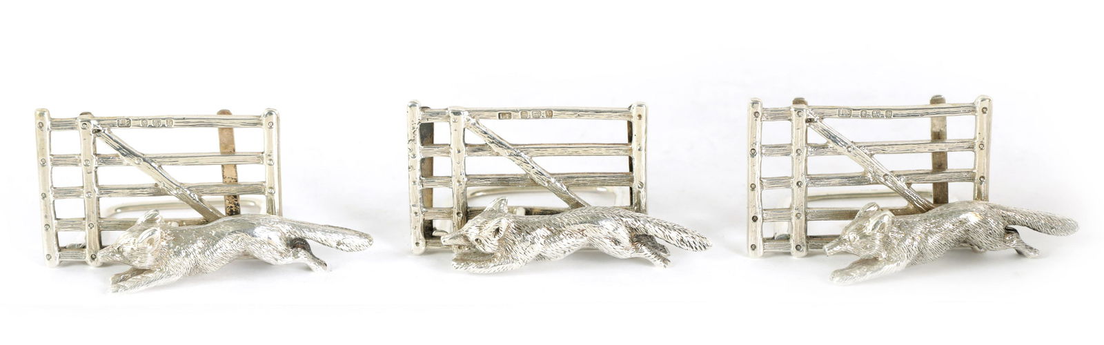 A SET OF THREE FOX AND GATE SILVER MENU HOLDERS (1 of 8)