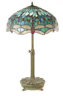 TIFFANY & CO. NEW YORK. A LARGE STYLISH ART NOUVEAU GREEN PATINATED BRONZE TELESCOPIC AND STAINED: TIFFANY & CO. NEW YORK. A LARGE STYLISH ART NOUVEAU BRONZE TELESCOPIC AND STAINED GLASS TABLE LAMP the shaped stem with lily pad design and adjustable column stamped underneath tiffany & Co New York a