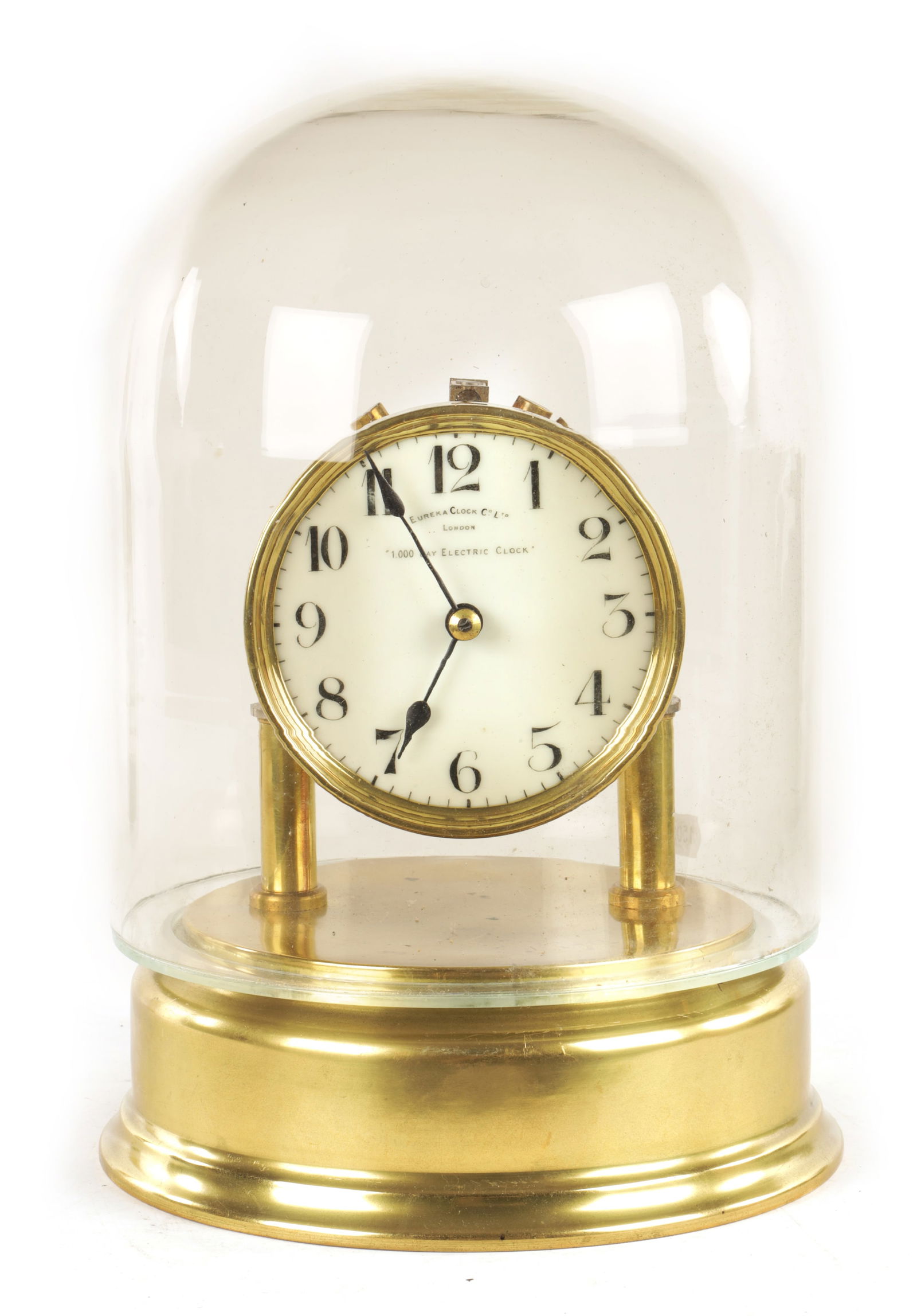 AN EARLY 20TH CENTURY ELECTRIC EUREKA MANTEL CLOCK: AN EARLY 20TH CENTURY ELECTRIC EUREKA MANTEL CLOCK having an enamel dial with Ararbic numerals fronting a brass battery powered movement with large weighted balance wheel pivoted on steel ball bearing