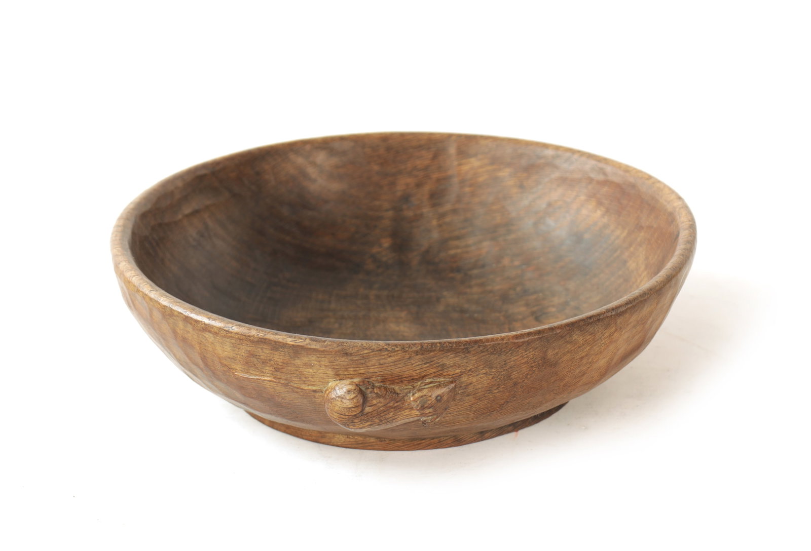 A ROBERT 'MOUSEMAN' THOMPSON ADZED DARK OAK FRUIT BOWL: A ROBERT 'MOUSEMAN' THOMPSON ADZED DARK OAK FRUIT BOWL with a shallow pedestal base and carved mouse trademark to the exterior. (24cm Diameter, 6.5cm high)