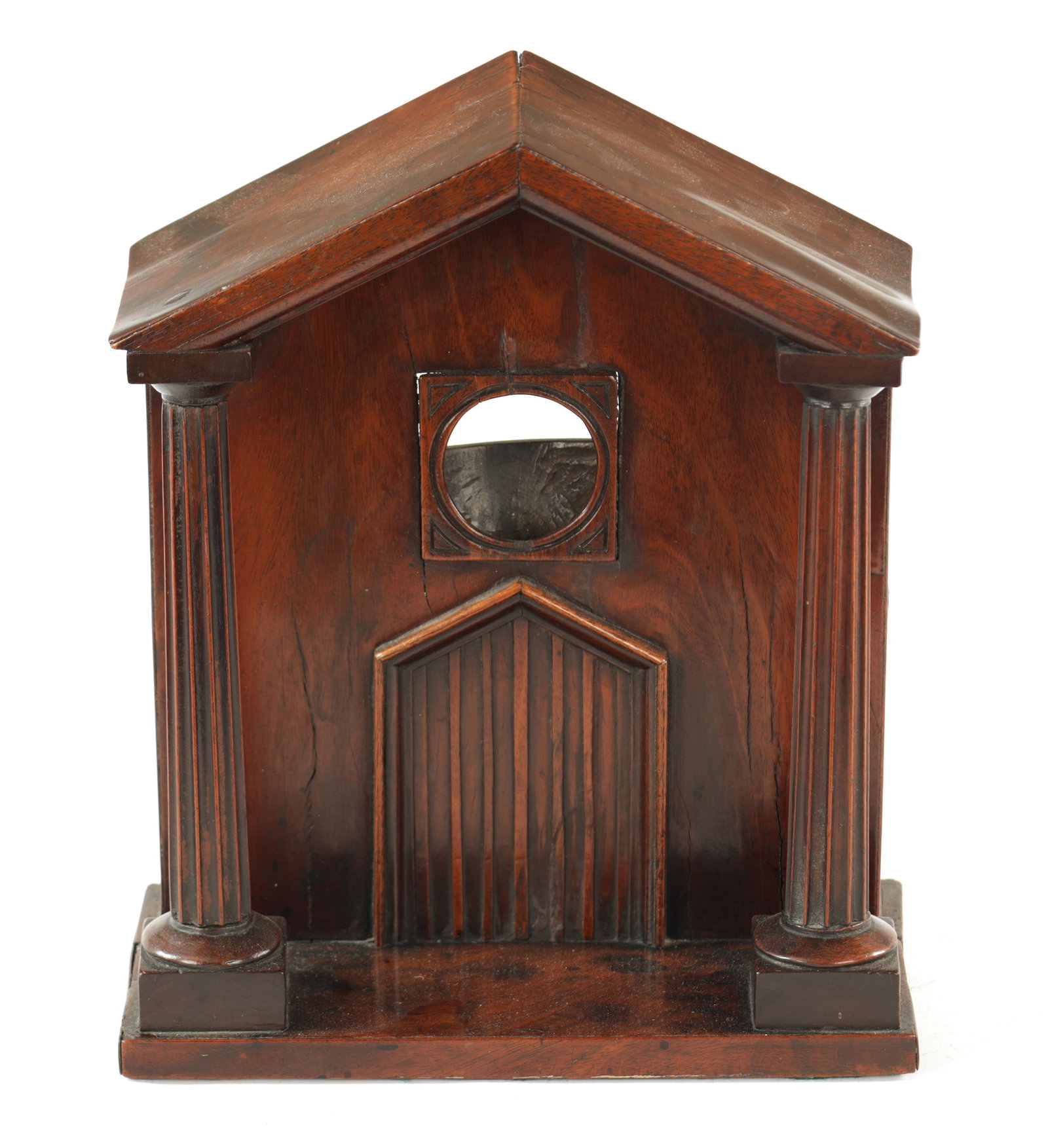 A GEORGE III MAHOGONY 'PORTICO' WATCH HOLDER: A GEORGE III MAHOGANY 'PORTICO' WATCH HOLDER of architectural form with Palladian pediment and free-standing reeded columns enclosing the doorway. (30cm high, 25.5cm wide )