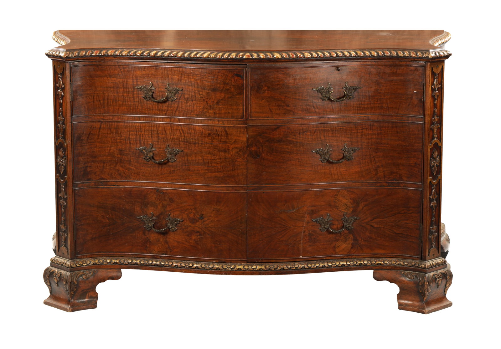 A LATE 19TH CENTURY GEORGE III STYLE MAHOGANY SERPENTINE CABINET IN THE MANNER OF THOMAS CHIPPENDALE: A LATE 19TH CENTURY GEORGE III STYLE MAHOGANY AND PARCEL GILT SERPENTINE CABINET IN THE MANNER OF THOMAS CHIPPENDALE with gadrooned moulded edge above dummy drawer cupboard front fitted with rococo st