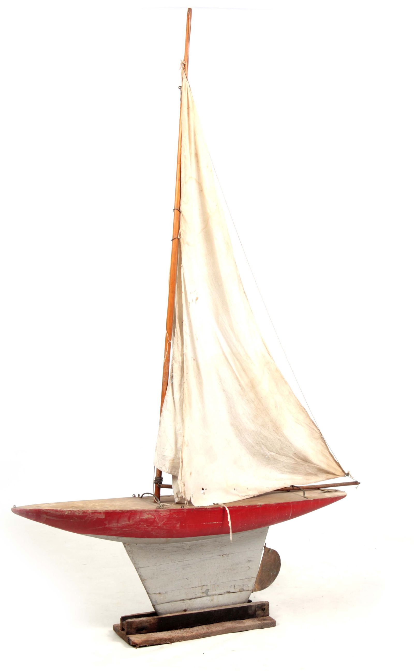 AN EARLY 20TH CENTURY WOOD POND YACHT: AN EARLY 20TH CENTURY WOOD POND YACHT with weighted keel and large sails (123cm wide 188cm high)
