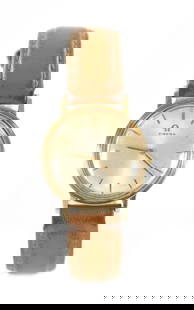 A 1960'S GENTLEMAN'S 9CT GOLD OMEGA DRESS WATCH: A 1960'S GENTLEMAN'S 9CT GOLD OMEGA DRESS WATCH the gold case enclosing a silvered dial with gold baton hour markers and Omega motif fronting a manual winding movement; on a brown leather strap,