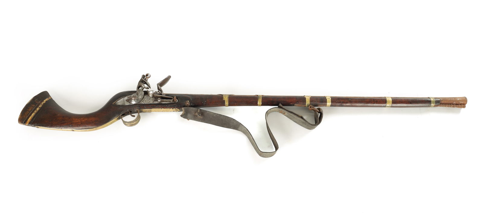 AN 18TH CENTURY TURKISH FLINTLOCK RIFLE: AN 18TH CENTURY TURKISH FLINTLOCK RIFLE on a full stock with brass bands and bone decoration to the butt, having engraved Islamic engraving to the steelwork. (122cm overall)