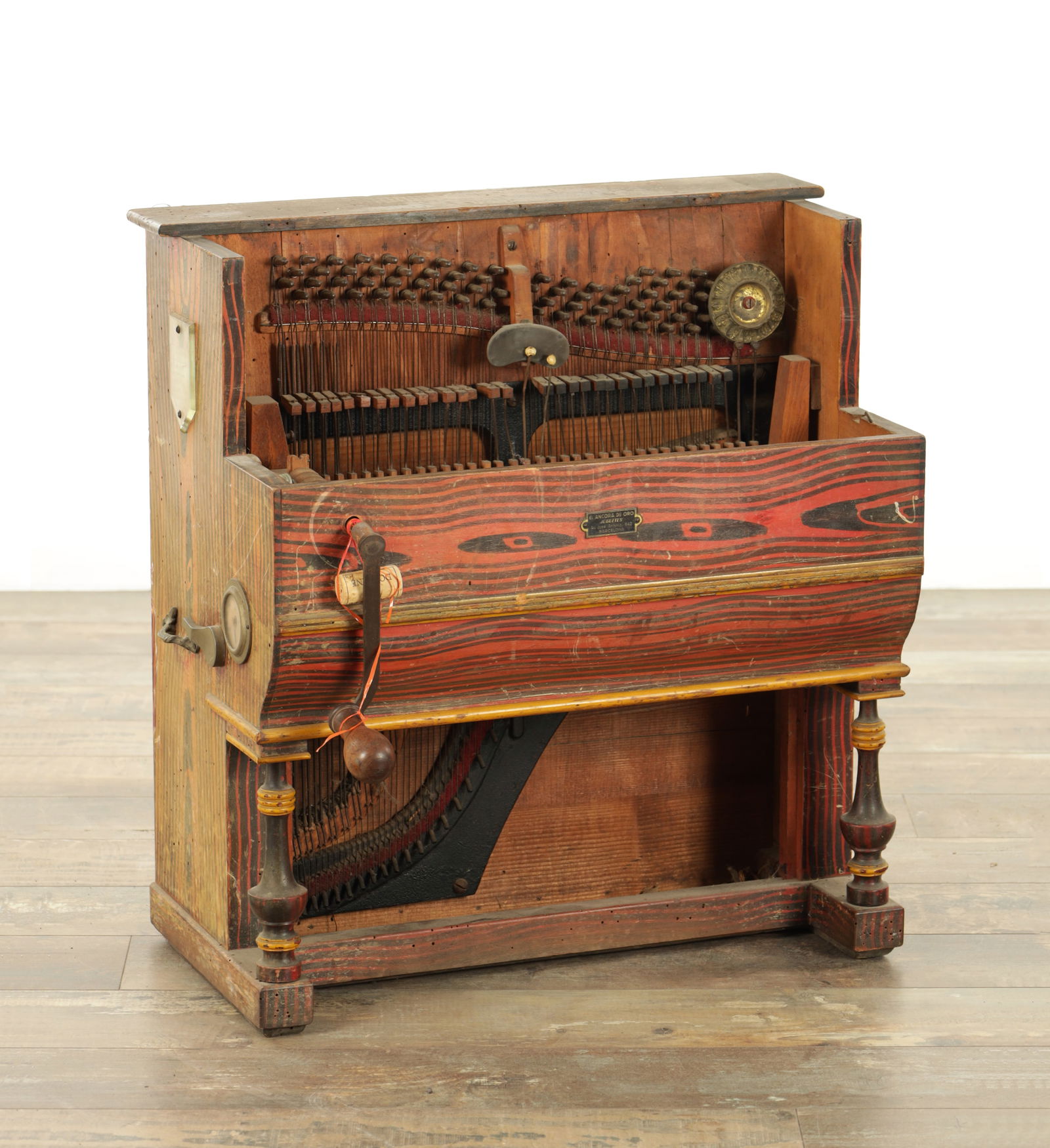 A 19TH CENTURY PIN BARREL ORGAN FORMED AS A PIANO: A 19TH CENTURY PIN BARREL ORGAN FORMED AS A PIANO with a scumbled case playing six tunes on a wooden pin barrel (54cm wide 60cm high )