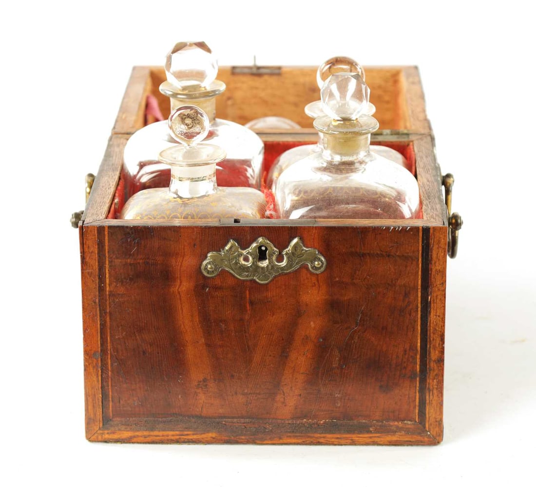AN EARLY 18TH CENTURY INLAID YEW WOOD VENEERED DECANTER BOX: AN EARLY 18TH CENTURY INLAID YEW WOOD VENEERED DECANTER BOX with hinged top revealing four gilt glass bottles and glass to the lid; fitted brass swan-neck carrying handles. 19cm wide 17cm deep 21cm hi