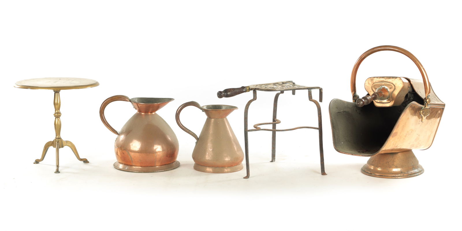 A VICTORIAN COPPER COAL SCUTTLE: A VICTORIAN COPPER COAL SCUTTLE together with two 19th century copper harvest measures, a Georgian engraved brass trivet and a circular hearth stand. (scuttle 46cm wide )