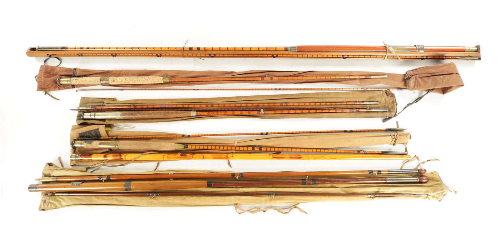 A COLLECTION OF FIVE VINTAGE HARDY FISHING RODS: A COLLECTION OF FIVE VINTAGE HARDY FISHING RODS, comprising of a split cane salmon rod in a wooden rod holder, a heartwood salmon rod, a split cane trout rod, another split cane trout rod, and a "HALF