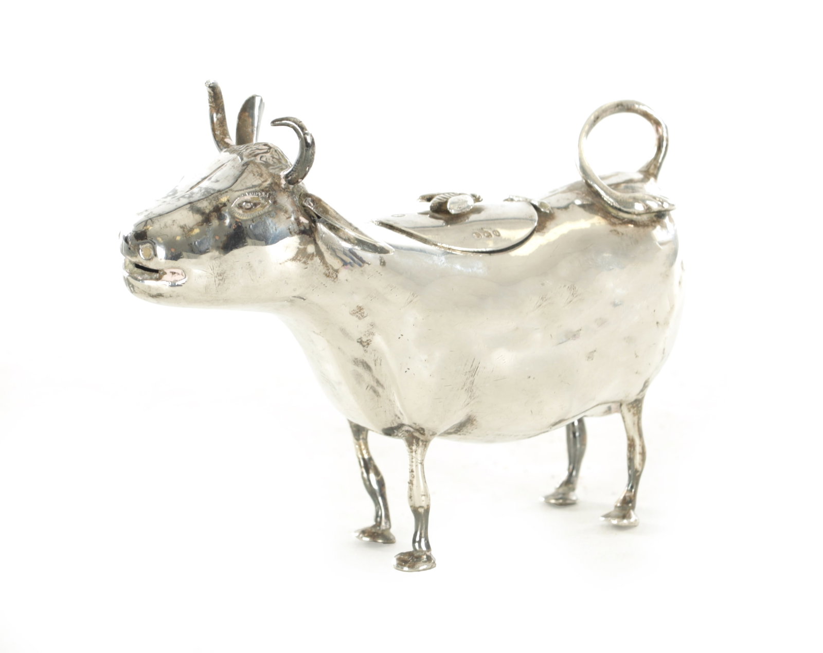 A DUTCH 19TH CENTURY SILVER COW CREAMER: A DUTCH 19TH CENTURY SILVER COW CREAMER, modelled as a standing cow with hinged lid mounted with a bee, English and Dutch hallmarks to the underside and lid. (10cm high)