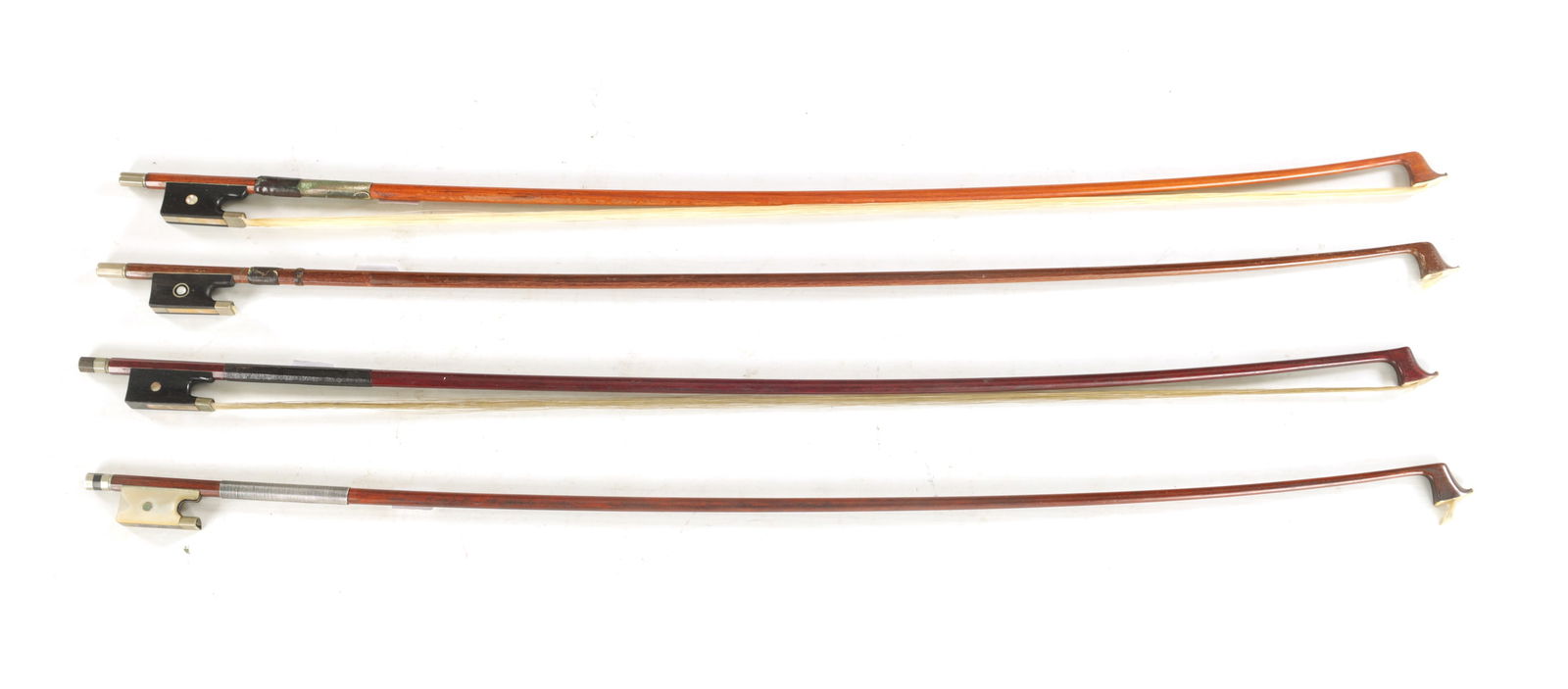 A COLLECTION OF FOUR VIOLIN BOWS: A COLLECTION OF FOUR VIOLIN BOWS, one having a mother-of-pearl frog with abalone eye, and another signed "BAUSCH". (4)