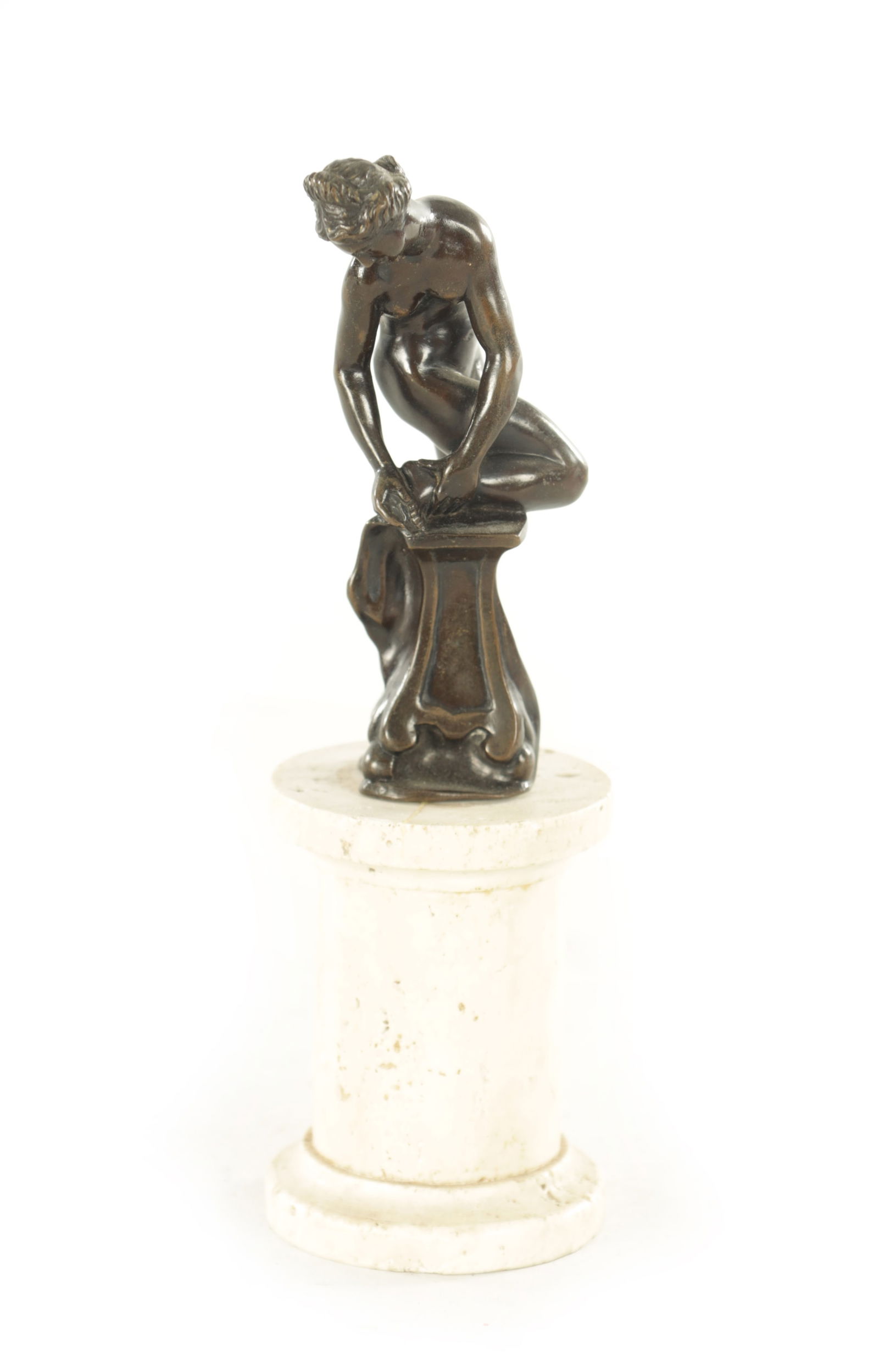 AFTER BARTHELEMY PRIEUR. A LATE 19TH CENTURY PATINATED BRONZE SCULPTURE: AFTER BARTHELEMY PRIEUR. A LATE 19TH CENTURY PATINATED BRONZE SCULPTURE, modelled as a maiden bathing, raised on a later travertine column base. (20cm high )