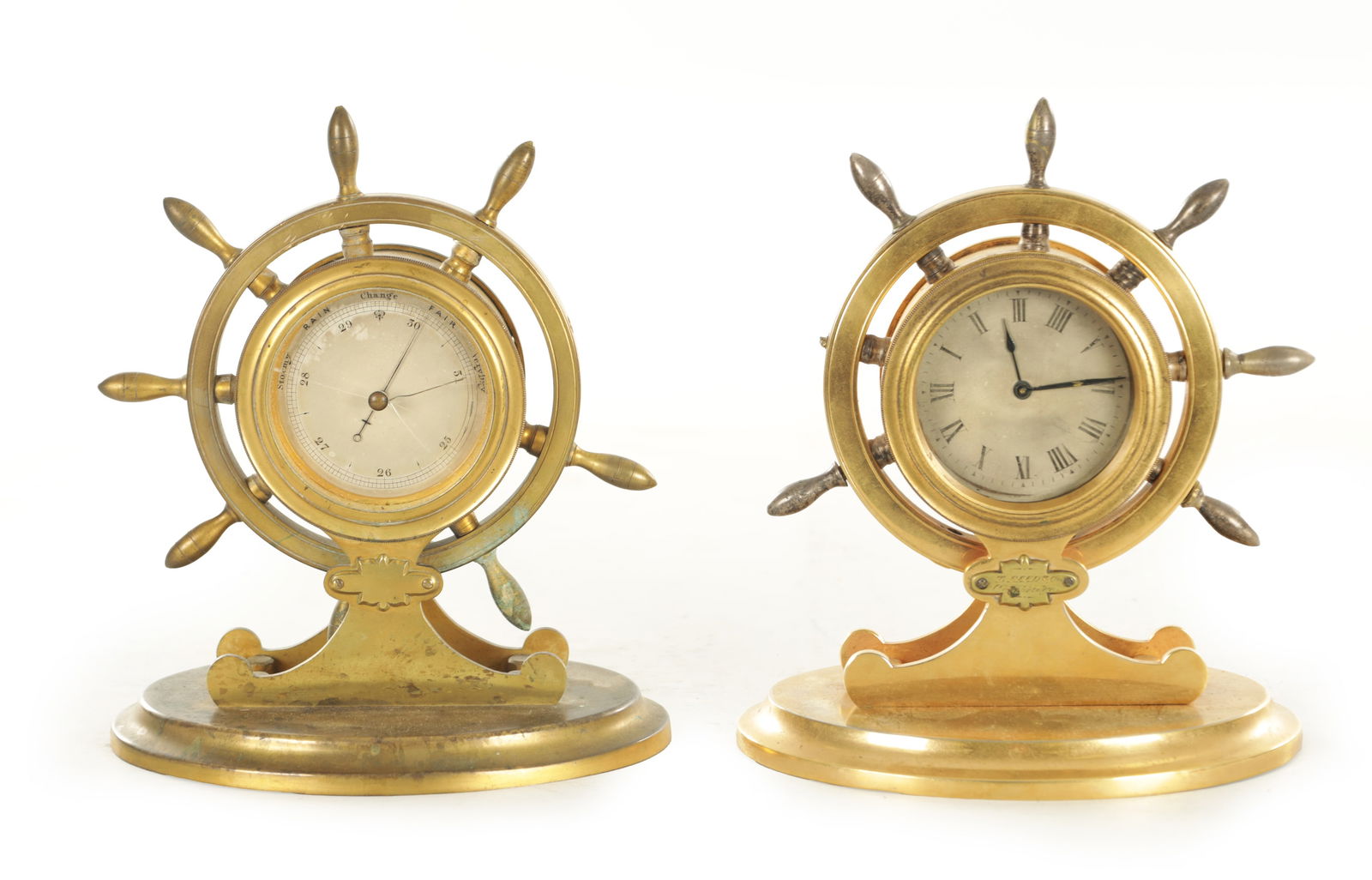 A PAIR OF LATE 19TH CENTURY FRENCH INDUSTRIAL DESK CLOCK BAROMETER: A PAIR OF LATE 19TH CENTURY FRENCH INDUSTRIAL DESK CLOCK BAROMETER of nautical interest, the gilt brass cases modelled as ships wheels on moulded oval bases, each with silvered dials for clock and bar