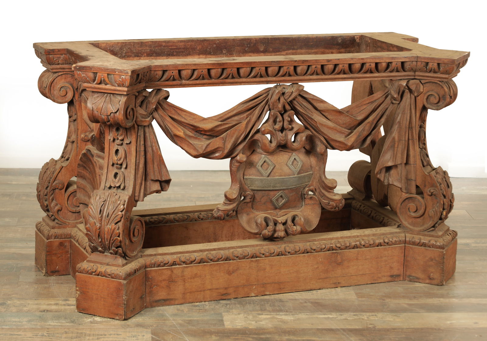 A RARE 18TH CENTURY STYLE CARVED PINE CONSOLE TABLE IN THE MANNER OF WILLIAM KENT: A RARE 18TH CENTURY STYLE CARVED PINE CONSOLE TABLE IN THE MANNER OF WILLIAM KENT with boldly carved scrolled leaf carved legs joined by draping swag work centralised by shells to the sides and coat o