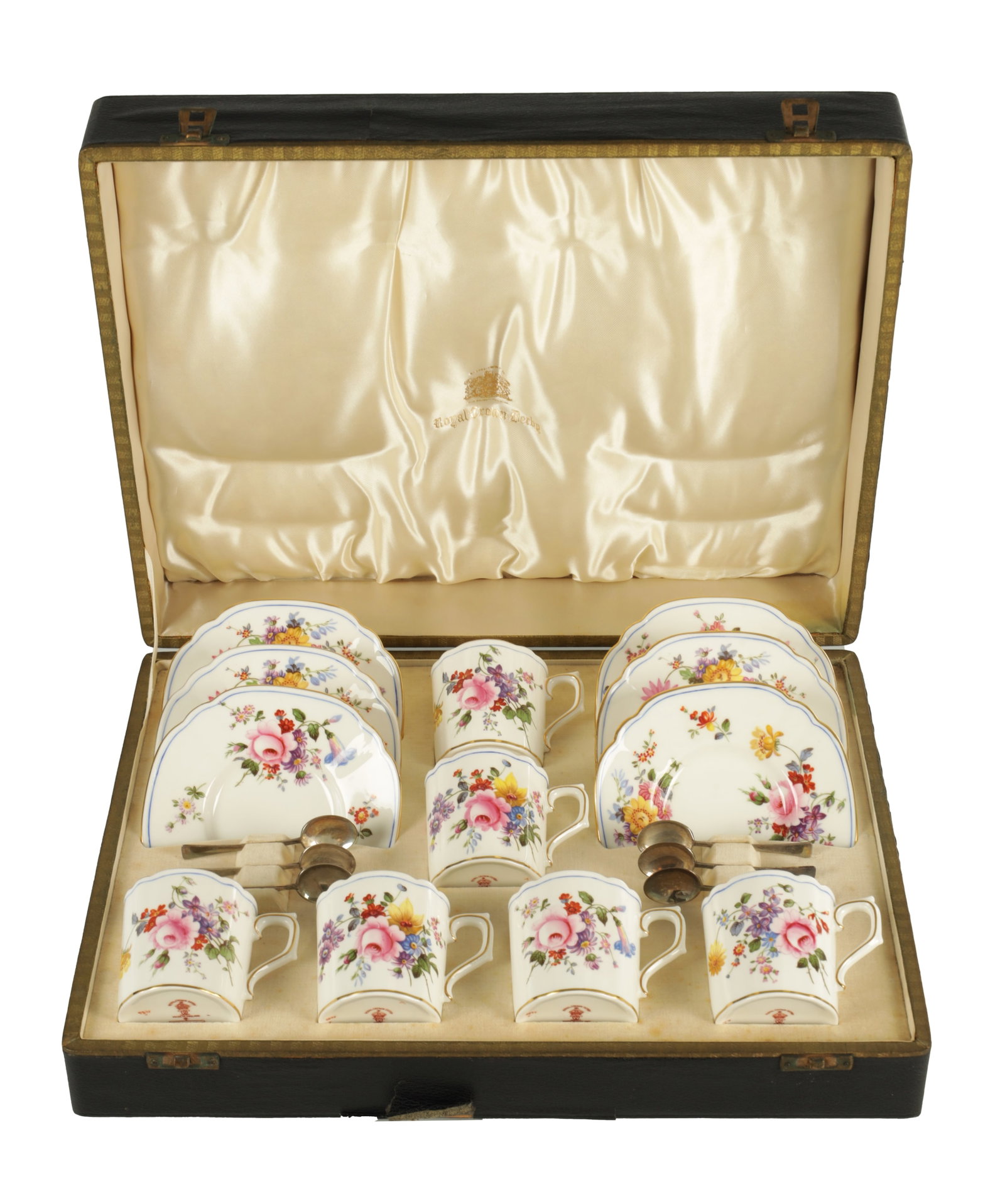 A CASED ROYAL CROWN DERBY SIX PIECE COFFEE SERVICE WITH SILVER SPOONS CIRCA 1930: A CASED ROYAL CROWN DERBY SIX PIECE COFFEE SERVICE WITH SILVER SPOONS CIRCA 1930 gilt-edged and painted with colourful flower sprays on a white ground, the silver spoons hallmarked for Birmingham 1934