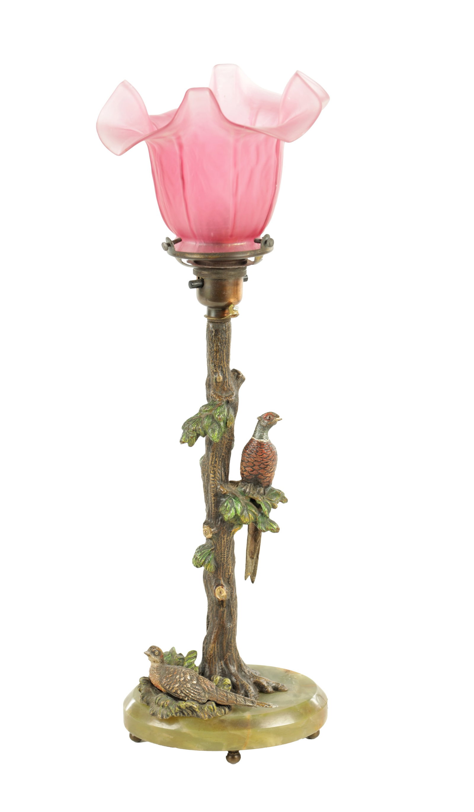 AN ART NOUVEAU AUSTRIAN COLD PAINTED BRONZE TABLE LAMP AND SHADE: AN ART NOUVEAU AUSTRIAN COLD PAINTED BRONZE TABLE LAMP AND SHADE depicting a tree and a pair of pheasants on an oval onyx base and bun feet, electrified and with fine pink tinted, folded flowerhead gl