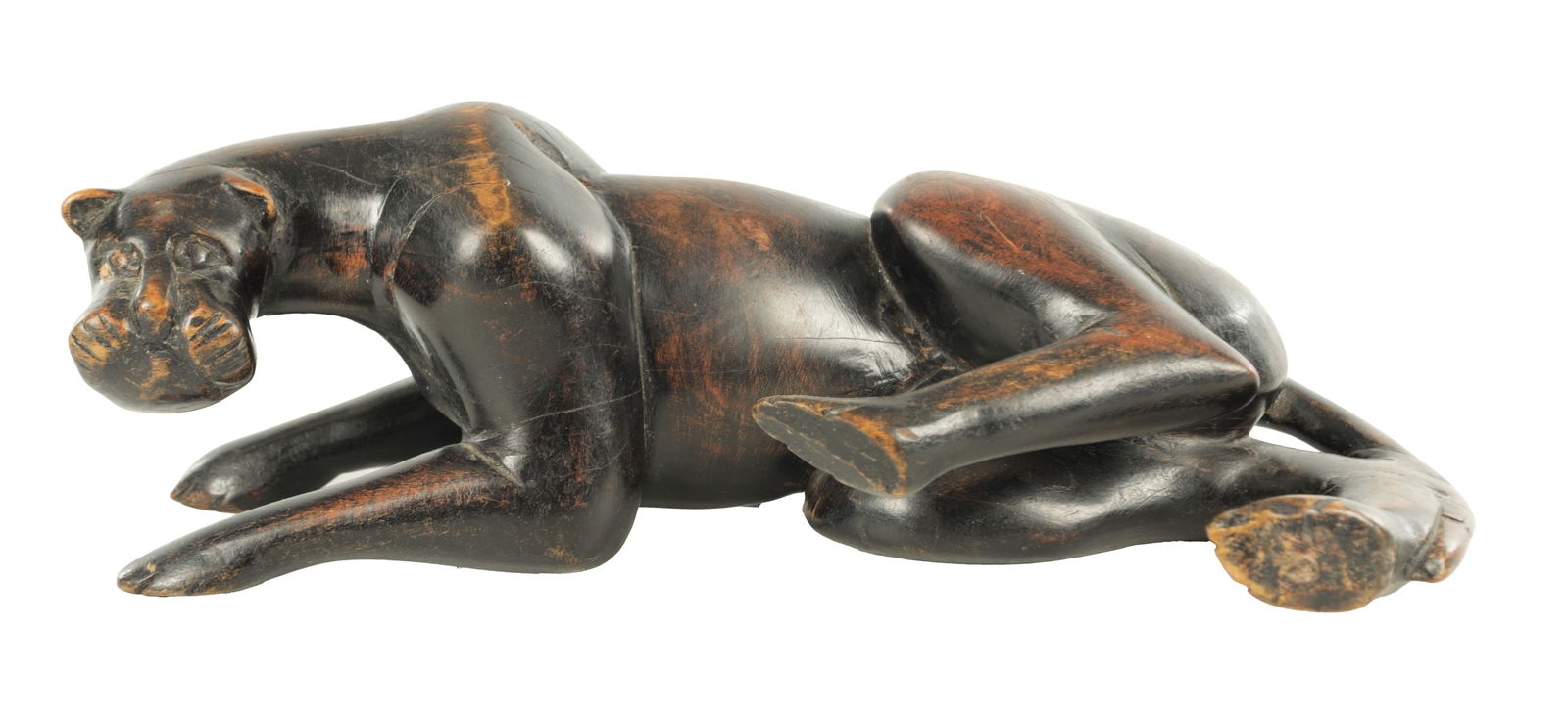 A 19TH/EARLY 20TH CENTURY CARVED STAINED HARDWOOD SCULPTURE OF A RECUMBENT BIG CAT: A 19TH/EARLY 20TH CENTURY CARVED STAINED HARDWOOD SCULPTURE OF A RECUMBENT BIG CAT (31cm length)