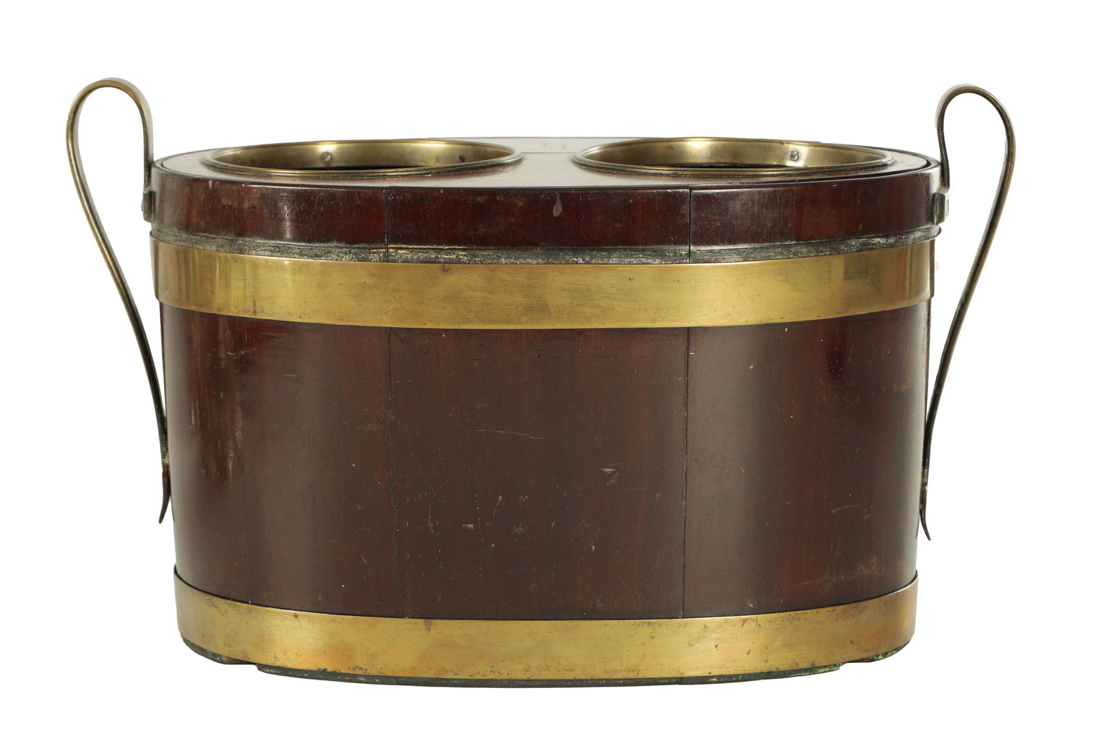 A RARE GEORGE III MAHOGANY AND BRASS BOUND TABLE TOP WINE COOLER: A RARE GEORGE III MAHOGANY AND BRASS BOUND TABLE TOP WINE COOLER of oval form for two bottles having a lift out top and lead liner, shaped side handles and coppered body (40cm wide 22cm deep 24cm high