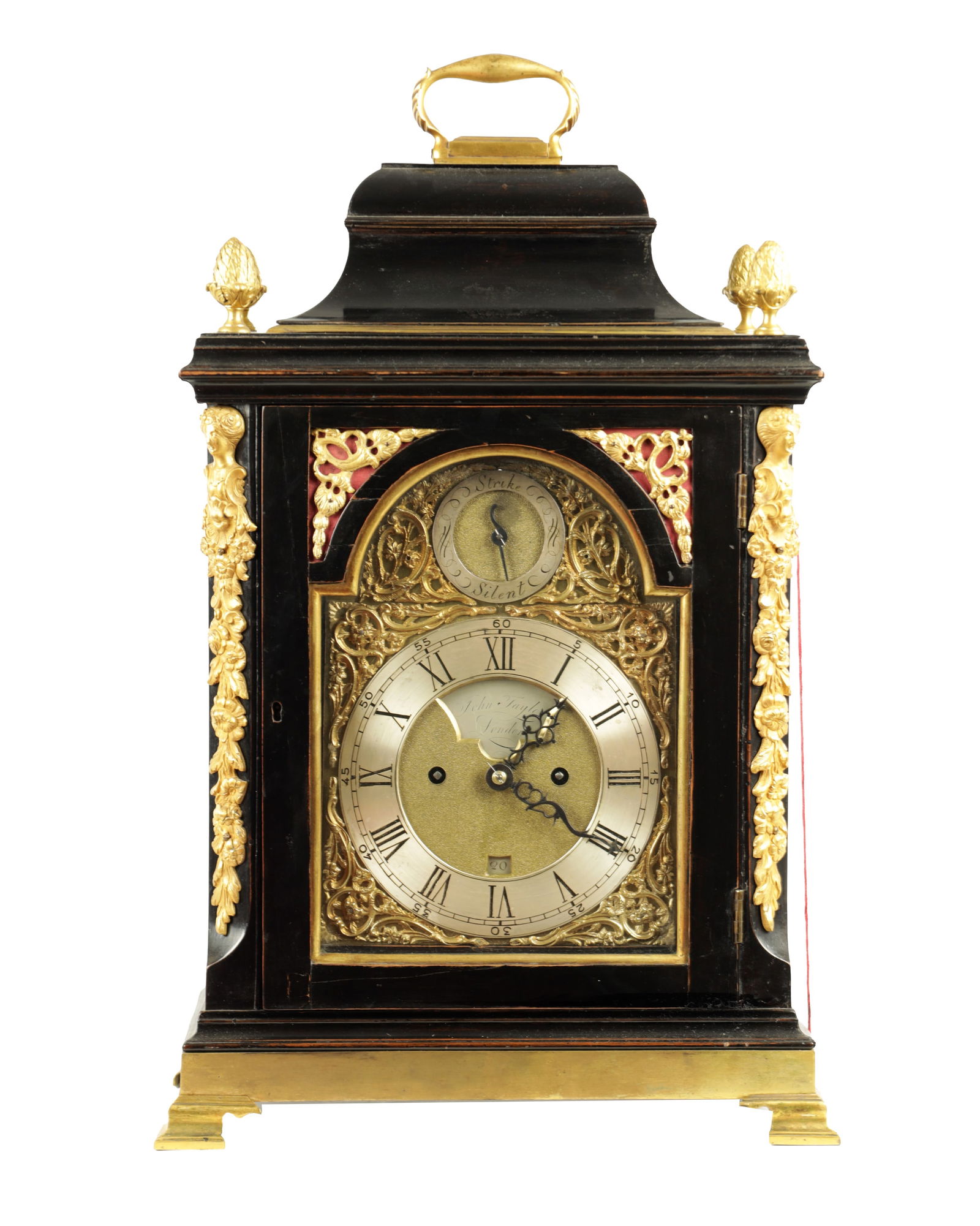 JOHN TAYLOR, LONDON. A GEORGE III ORMOLU MOUNTED EBONISED VERGE BRACKET CLOCK: JOHN TAYLOR, LONDON. A GEORGE III ORMOLU MOUNTED EBONISED VERGE BRACKET CLOCK, the bell top case with pineapple finials and canted caryatid corners on ogee bracket feet. The arched 7" brass and silver