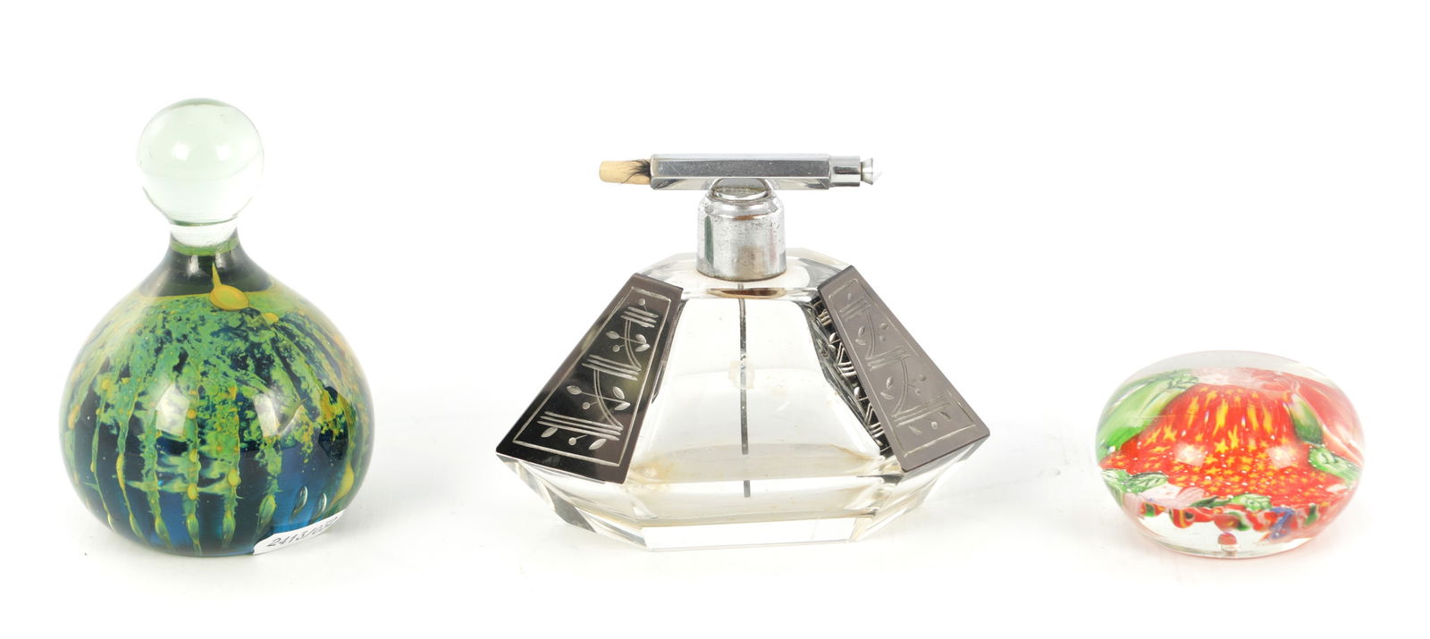 AN ART DECO GLASS ATOMIZER PERFUME BOTTLE: AN ART DECO GLASS ATOMIZER PERFUME BOTTLE of hexagonal form with faceted body having etched black panels and chrome mount, together with two glass paperweights. (3) (12cm wide, 9.5cm high )