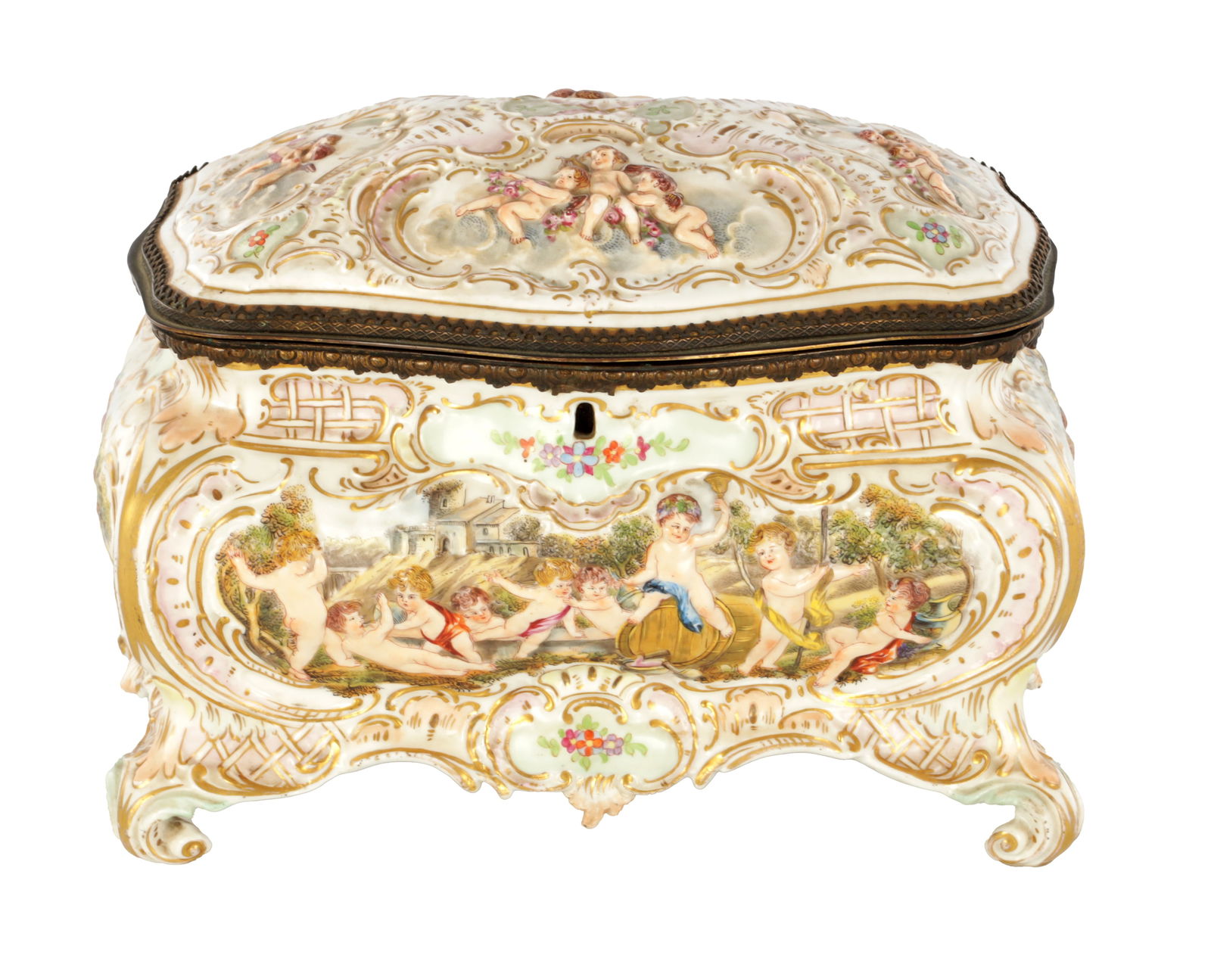 A LATE 19TH CENTURY ITALIAN CAPODIMONTE GILT METAL MOUNTED PORCELAIN TABLE JEWELLERY CASKET: A LATE 19TH CENTURY ITALIAN CAPODIMONTE GILT METAL MOUNTED PORCELAIN TABLE JEWELLERY CASKET the serpentine bombe-shaped body with high relief moulded designs of cherubs playing in garden settings, bel