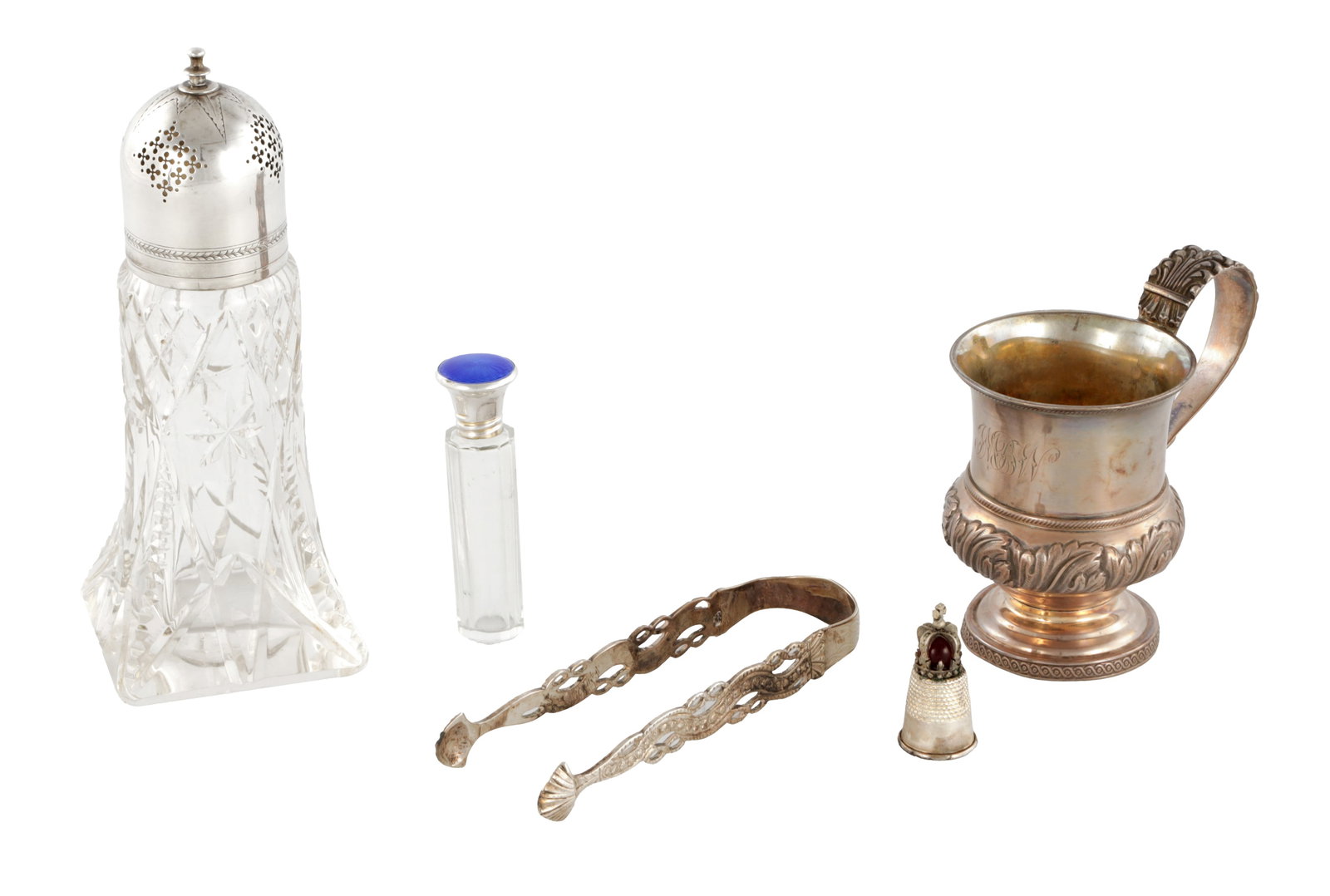 A COLLECTION OF SILVER ITEMS: A COLLECTION OF SILVER ITEMS comprising a cut glass and mounted sugar caster, blue enamel topped scent bottle, small bulbous mug, tongs and a crown topped thimble, total silver weight approx 180g.