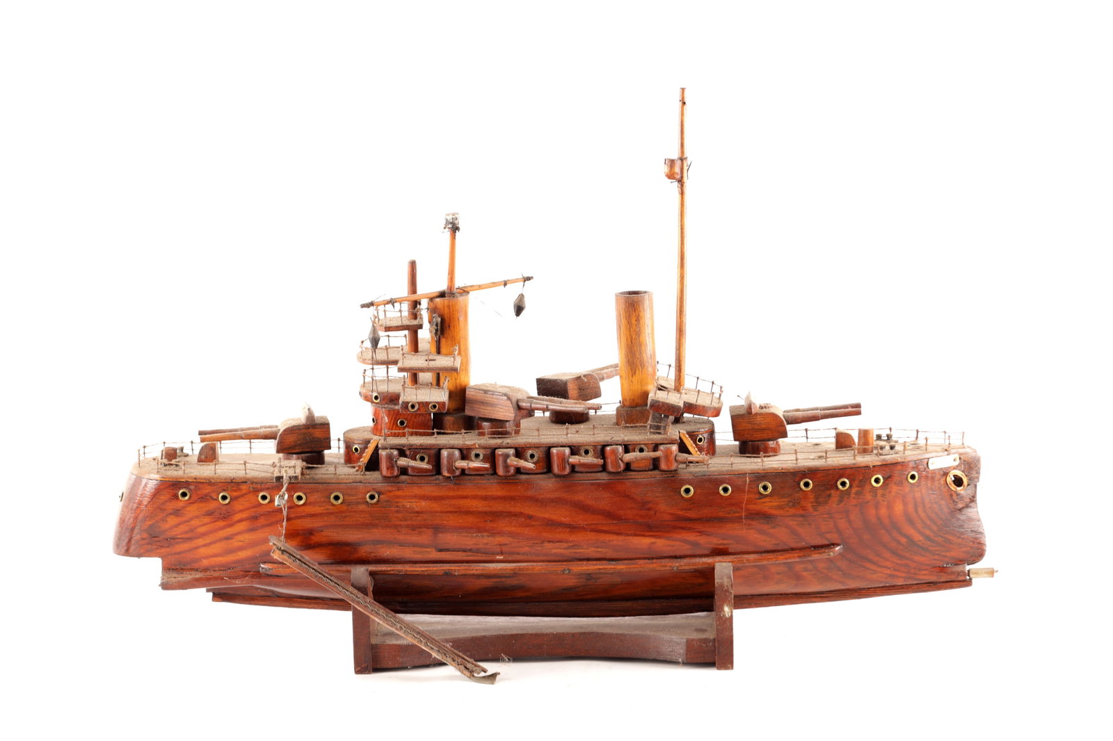 AN EARLY 20TH CENTURY WOODEN MODEL OF A GERMAN NAVAL WARSHIP: AN EARLY 20TH CENTURY WOODEN MODEL OF A GERMAN NAVAL WARSHIP with masts, funnels and rotating guns, the bow with brass name plaque for "GOEBEN". (67cm long)