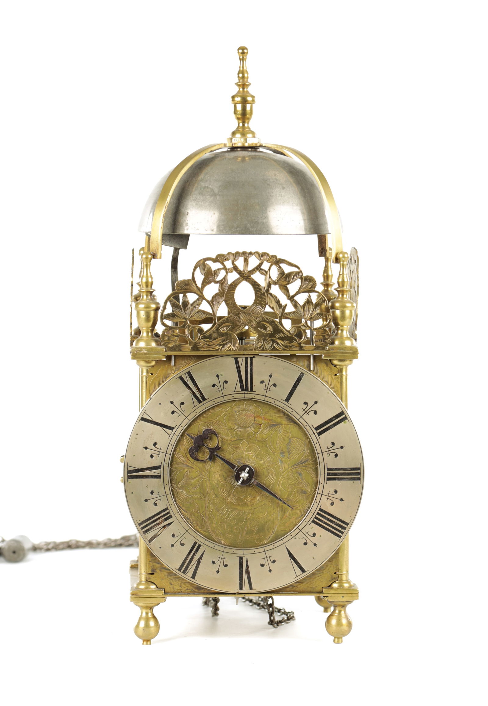 WILLIAM RAYNES IN YORKE (YORK). A LATE 17TH CENTURY ENGLISH BRASS LANTERN CLOCK: WILLIAM RAYNES IN YORKE (YORK). A LATE 17TH CENTURY ENGLISH BRASS LANTERN CLOCK the posted frame with side doors, engraved dolphin fretwork crestings and strapped bell surmounted by a large final abov