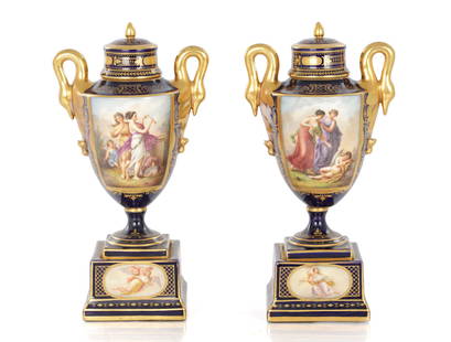 A PAIR OF 19TH CENTURY VIENNA PORCELAIN VASE AND COVERS: A PAIR OF 19TH CENTURY VIENNA PORCELAIN VASE AND COVERS of urn-shaped form with swan neck handles, with flat domed lids and painted panels depicting classical scenes on square moulded bases.