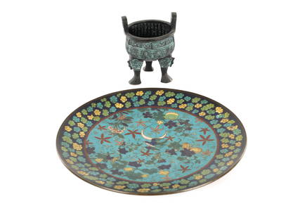 A CHINESE CLOISONNE ENAMEL CHARGER AND A BRONZE CENSER: A CHINESE CLOISONNE ENAMEL CHARGER AND A BRONZE CENSER, the enamel charger decorated with a bird amongst blossoming branches, together with a bronze three-legged censer with an impressed seal mark. (2